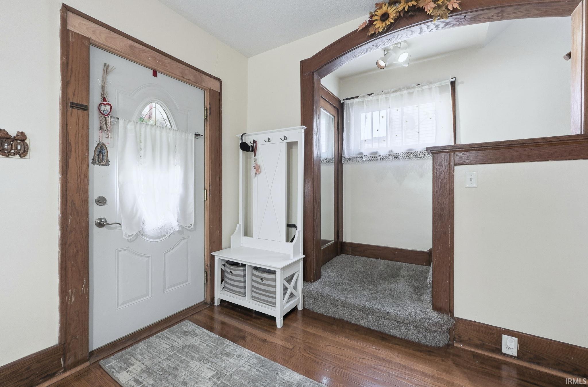 Entrance foyer featuring healthy amount of natural light and dark wood finished floors