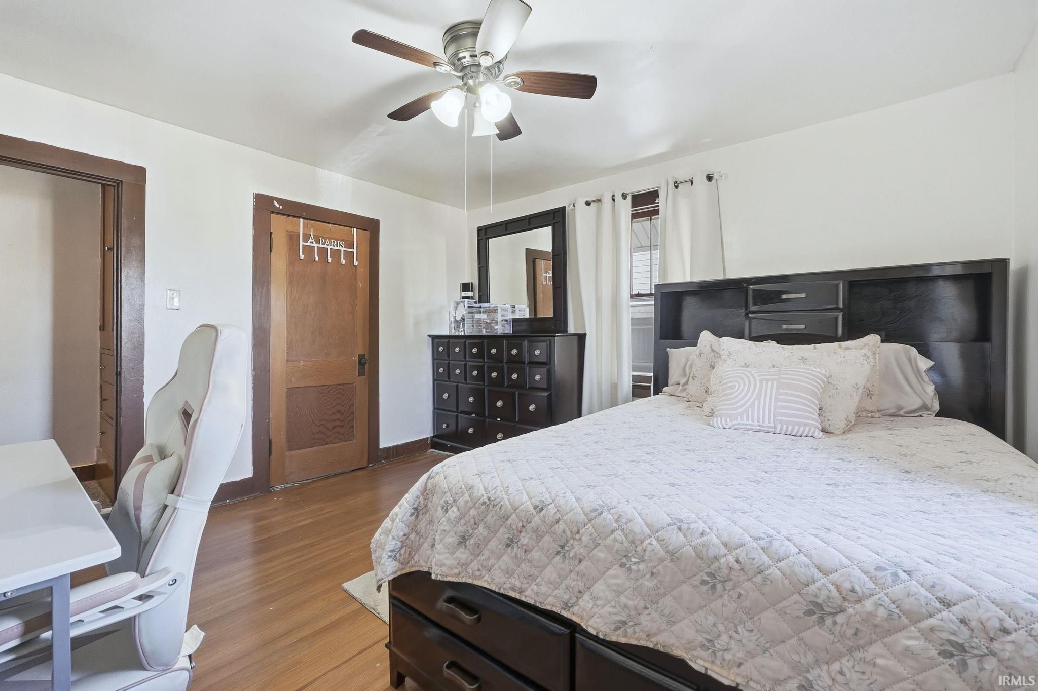 Bedroom featuring wood finished floors and a ceiling fan