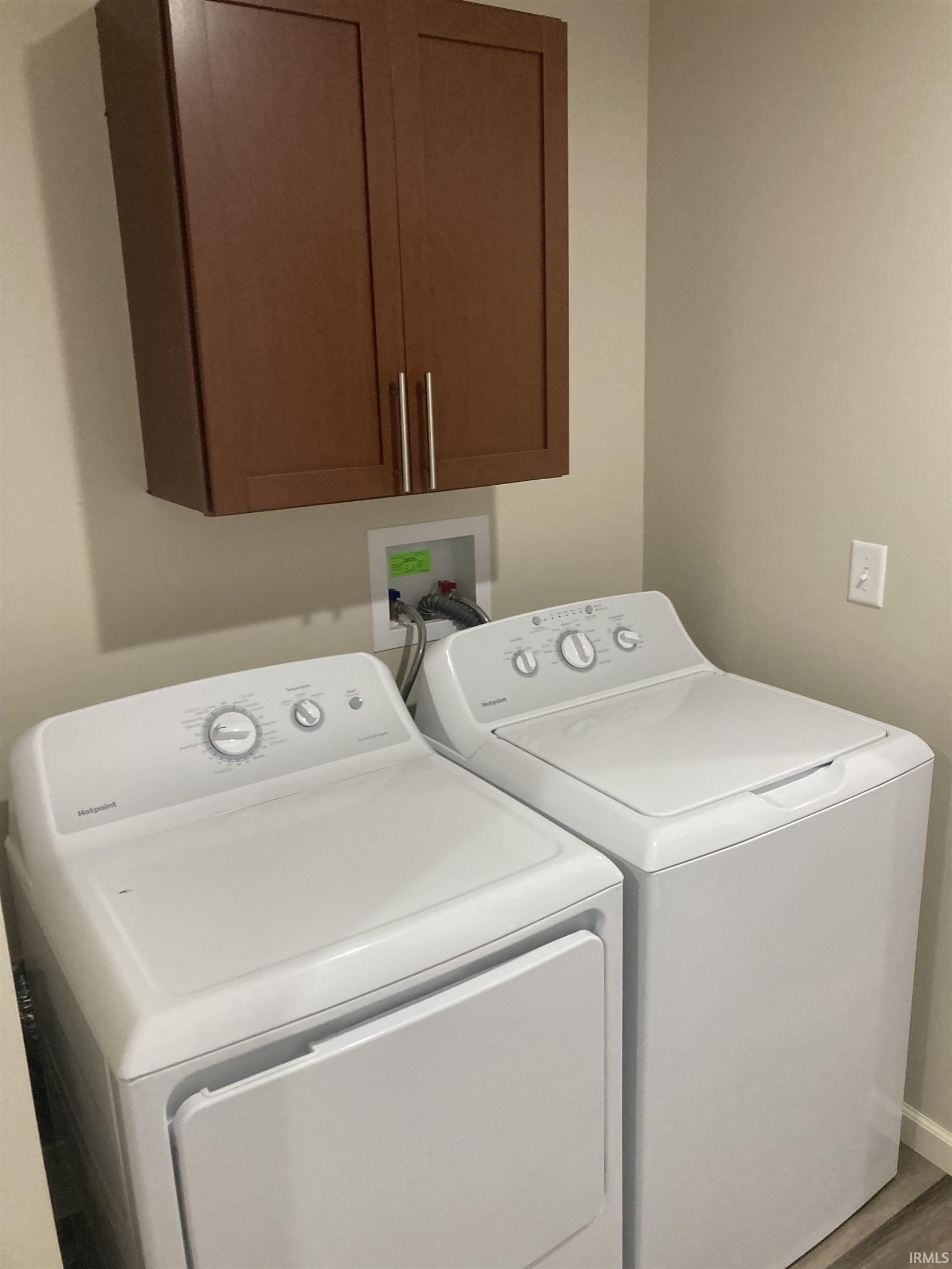 Laundry room with washing machine and dryer and cabinet space