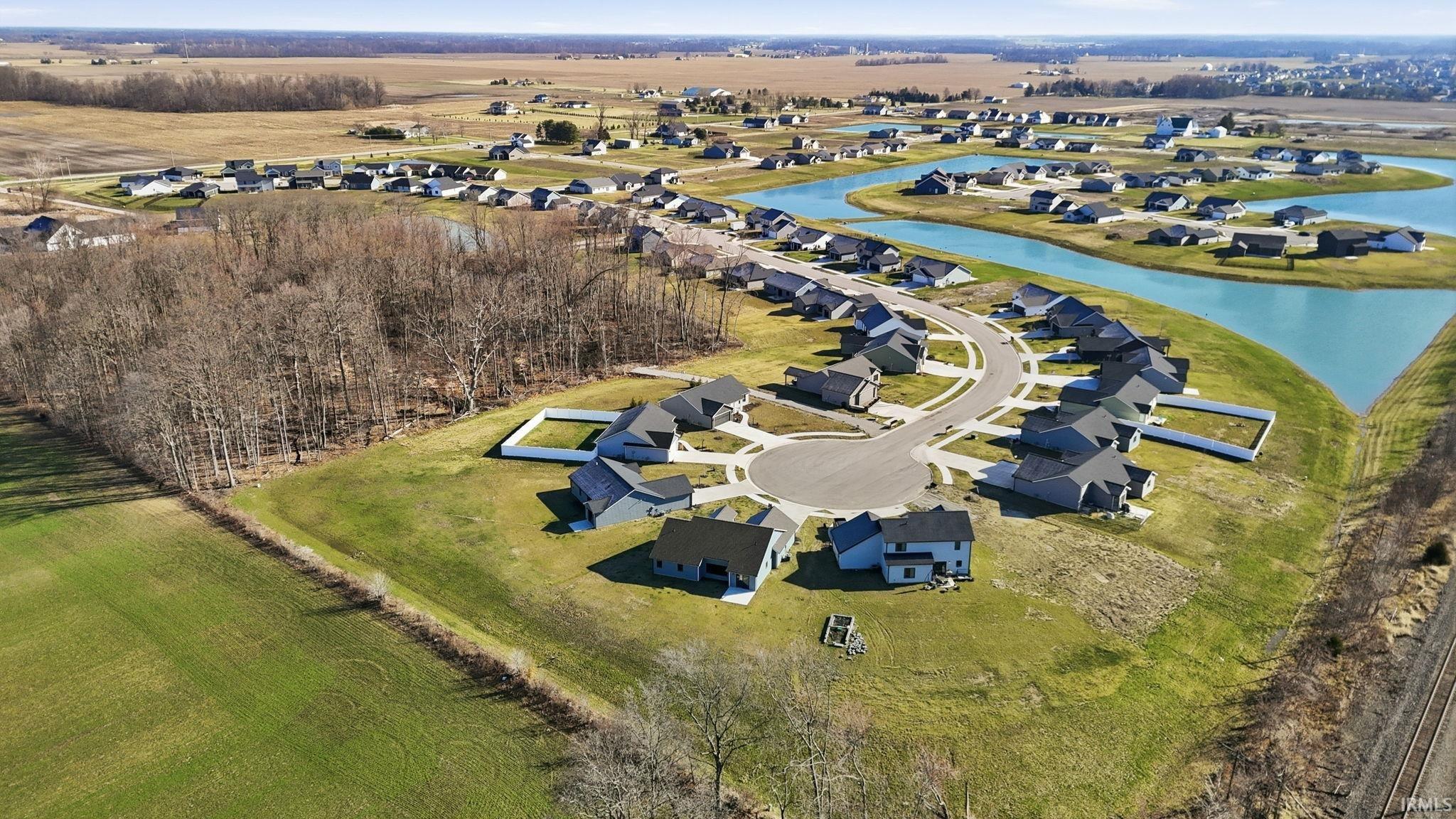 Aerial view of residential area featuring a large body of water