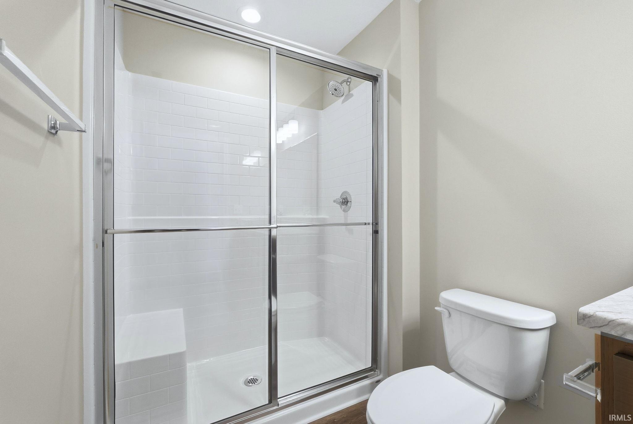 Bathroom featuring vanity, a shower stall, and recessed lighting
