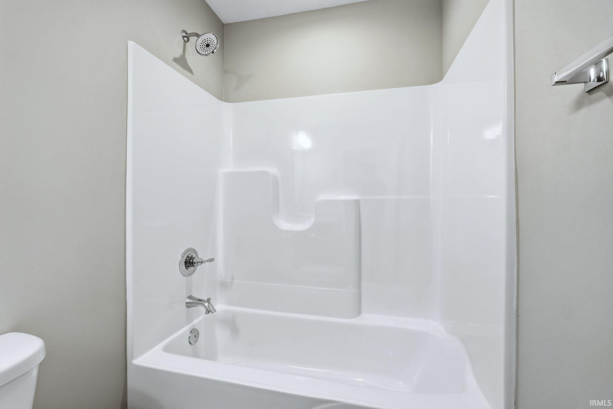 Bathroom featuring toilet and shower / tub combination