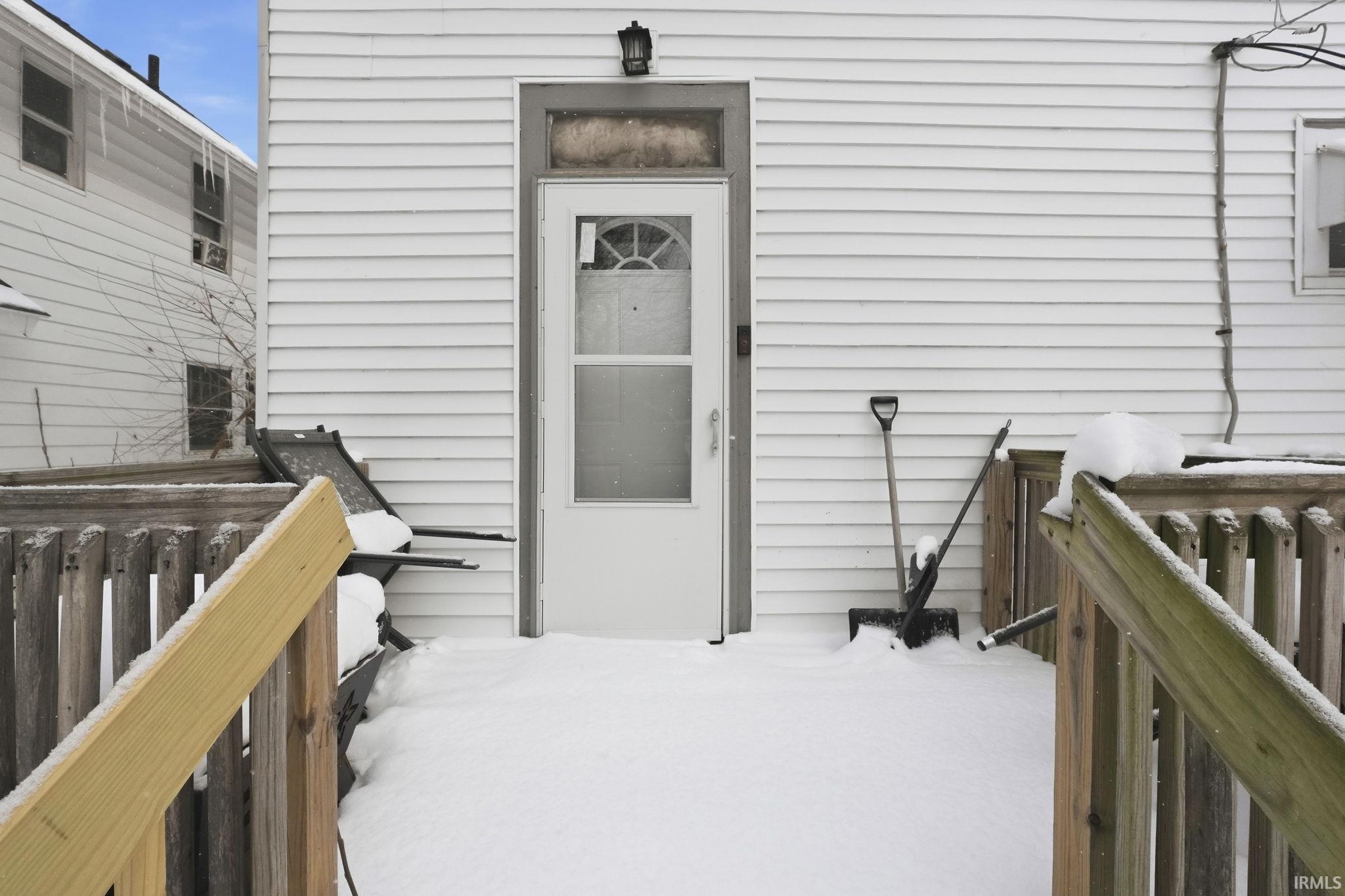 Doorway to property with a wooden deck