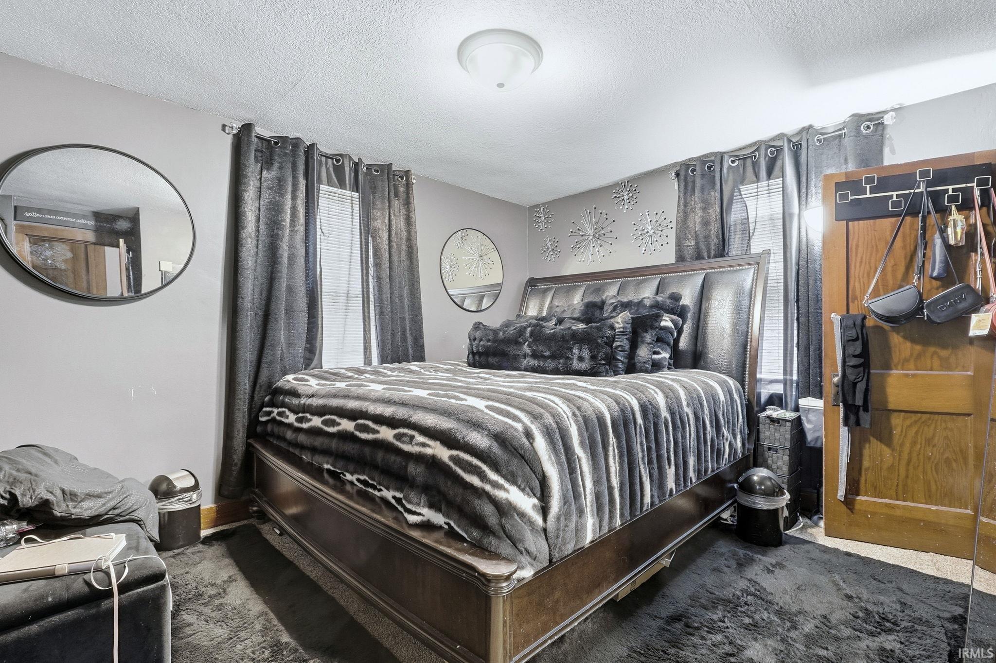 Bedroom featuring a textured ceiling and carpet floors