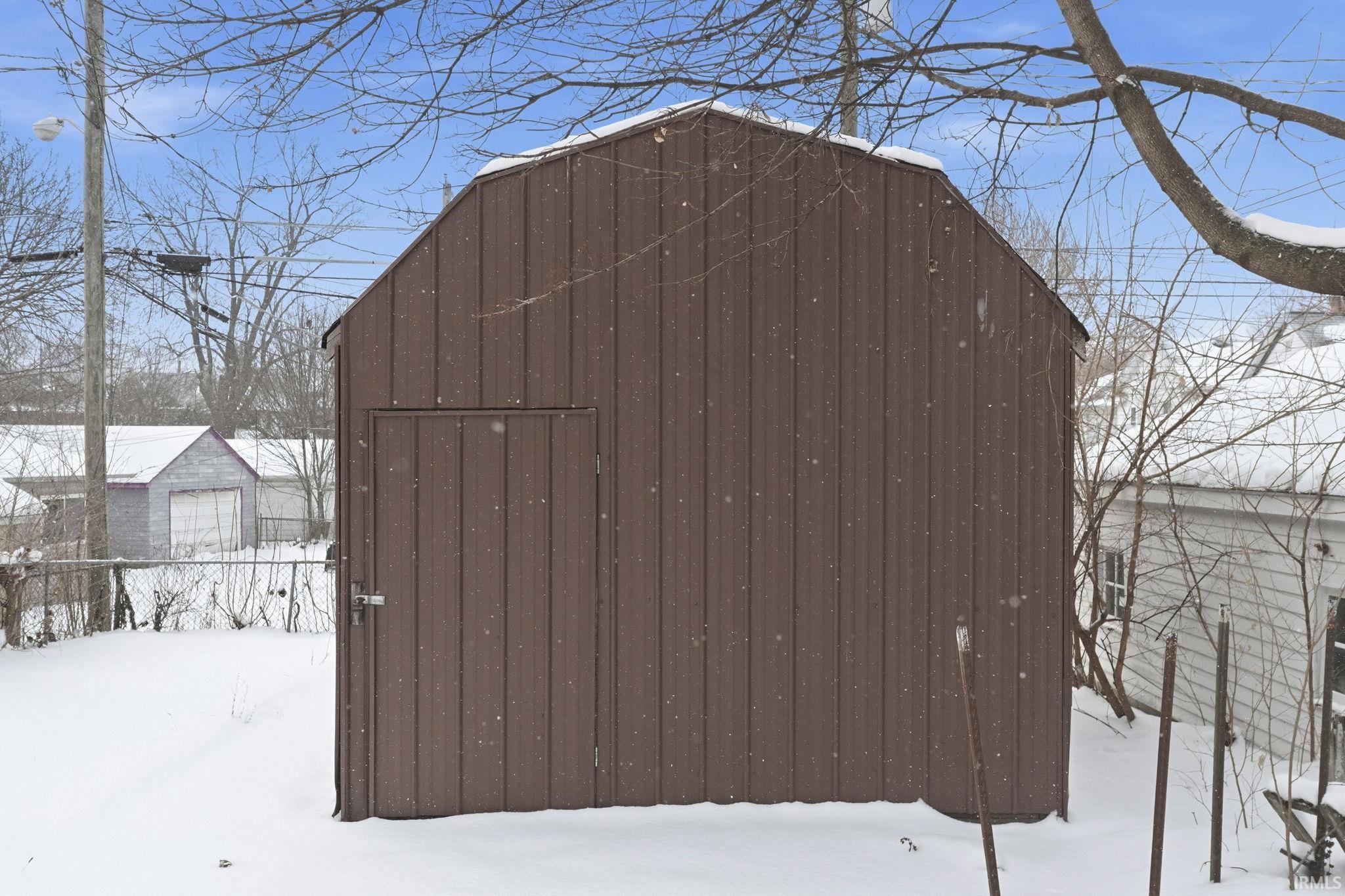 Snow covered structure with a storage unit
