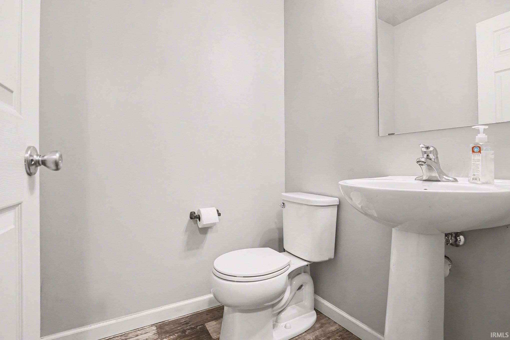 Bathroom with wood finished floors and toilet