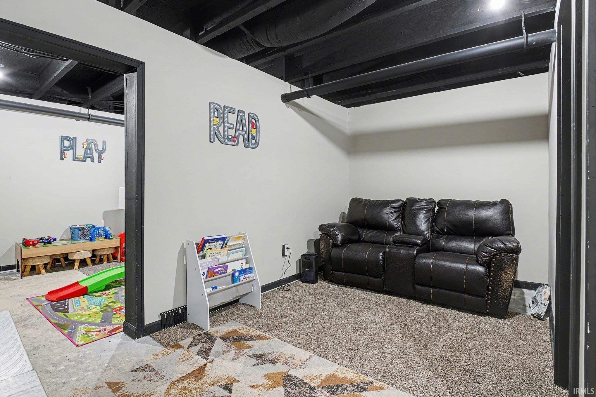 Carpeted cinema room featuring baseboards