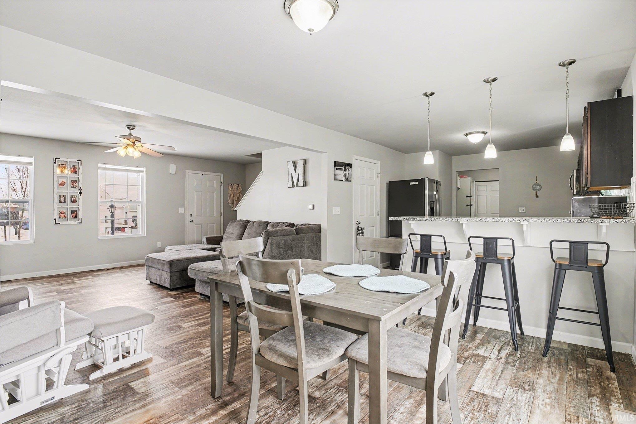 Dining room featuring ceiling fan and light wood-style floors