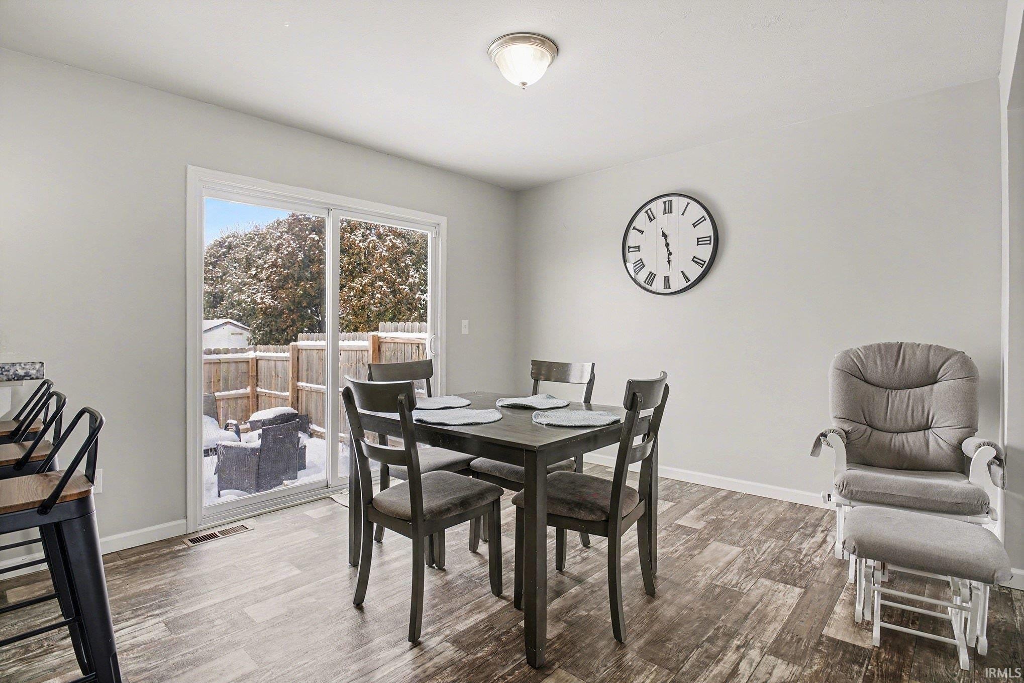 Dining space featuring wood finished floors and baseboards