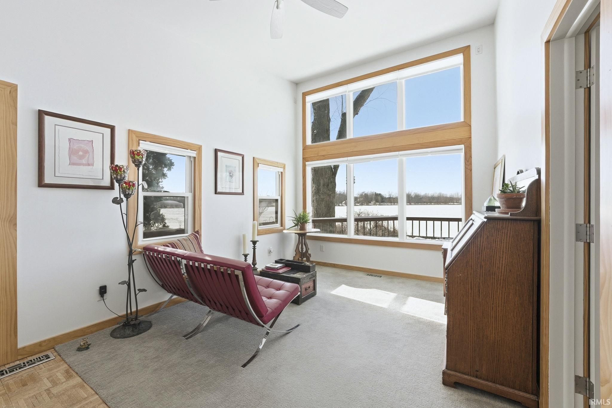 Living area with baseboards and a ceiling fan
