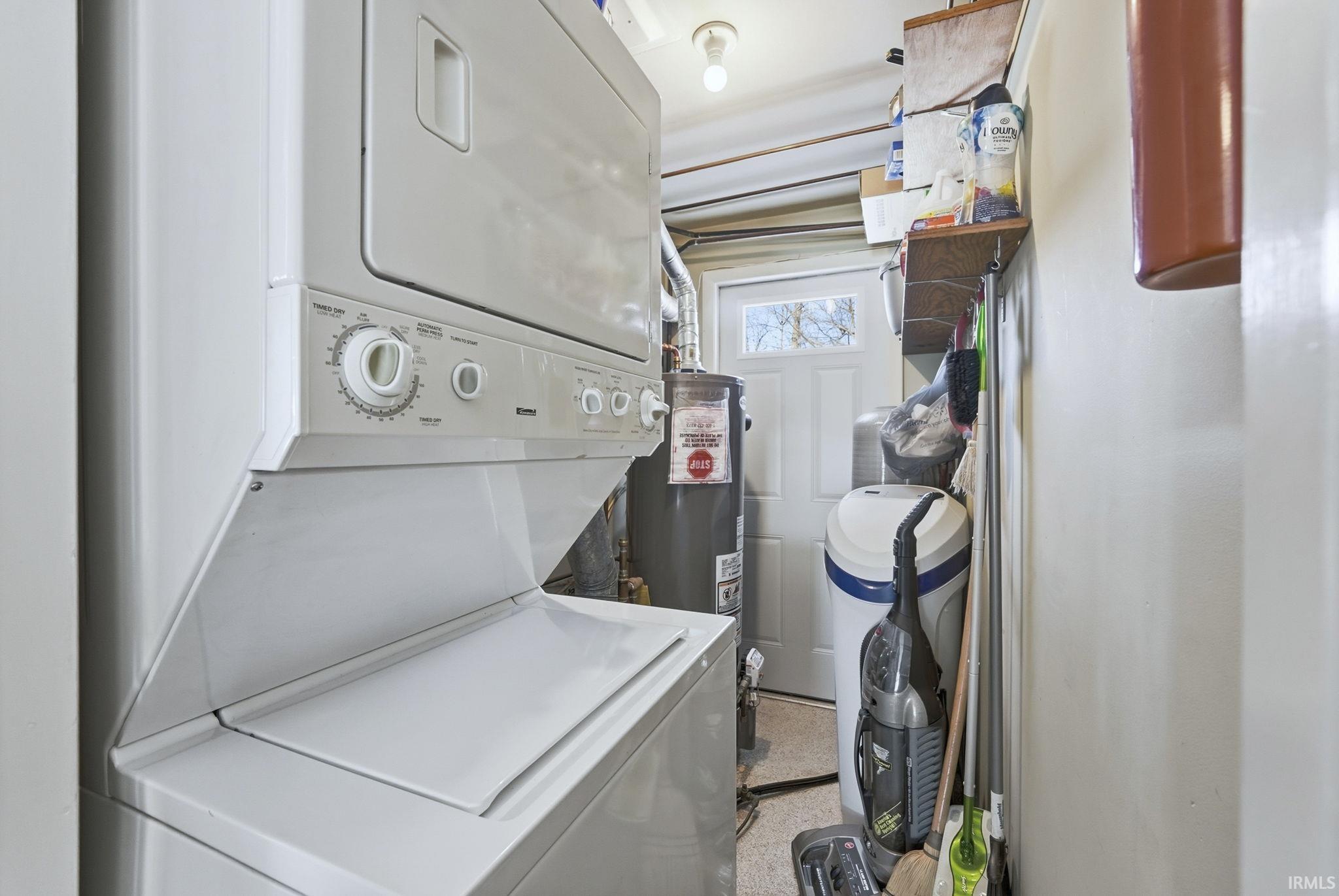 Laundry area with stacked washer and clothes dryer