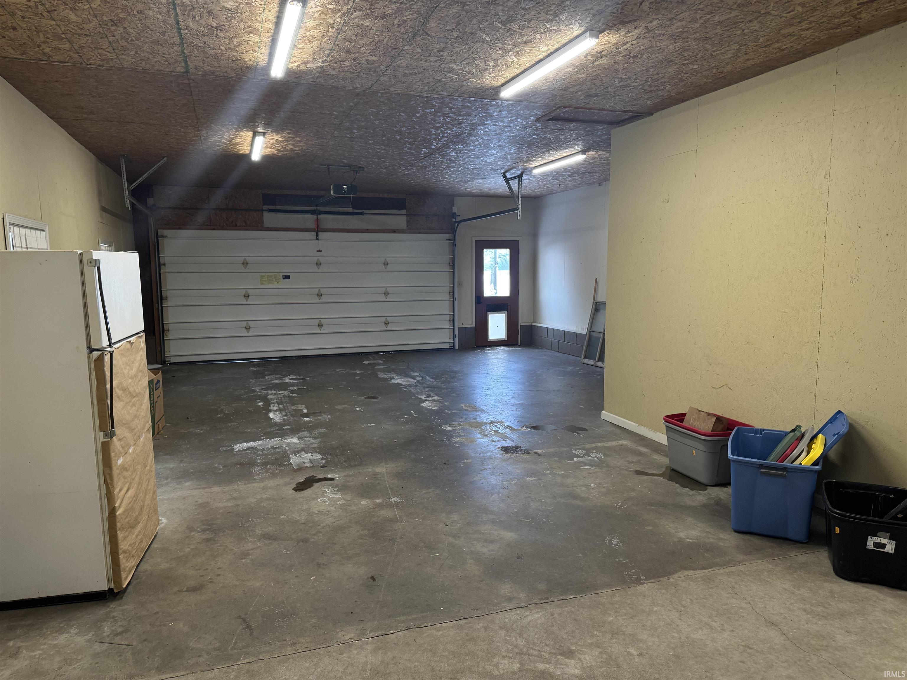 Garage with freestanding refrigerator