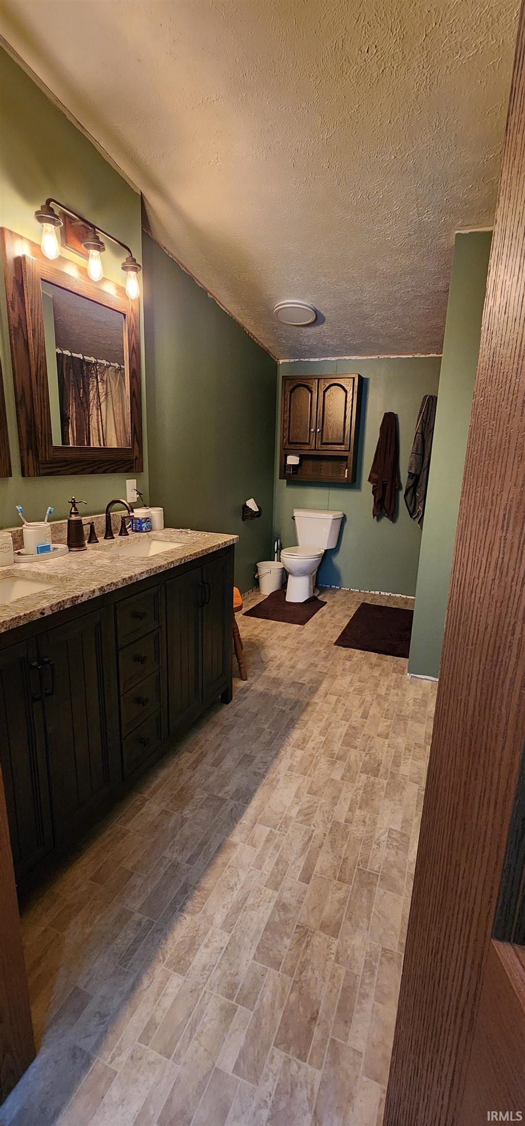 Full bath with vanity and a shower with shower curtain