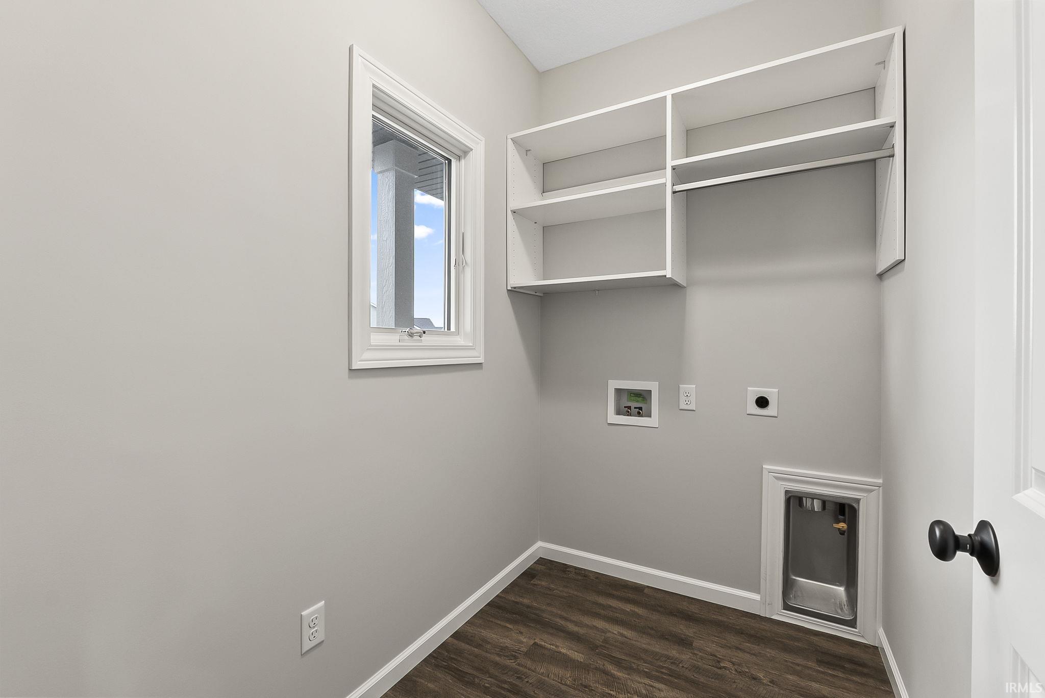 Laundry room with dark wood-style floors, hookup for a washing machine, and electric dryer hookup