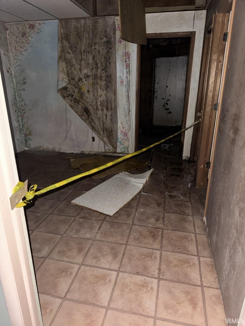 Corridor featuring light tile patterned floors