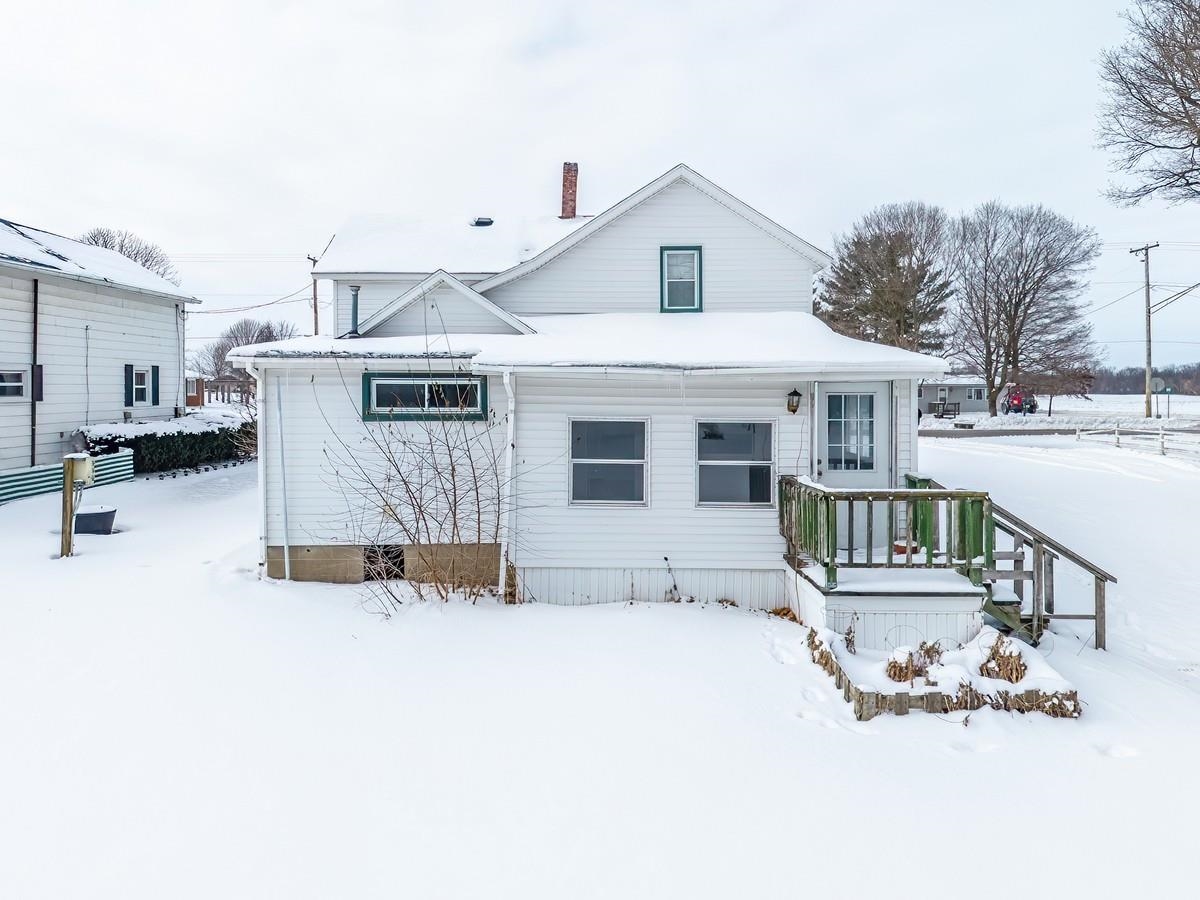 View of snow covered back of property