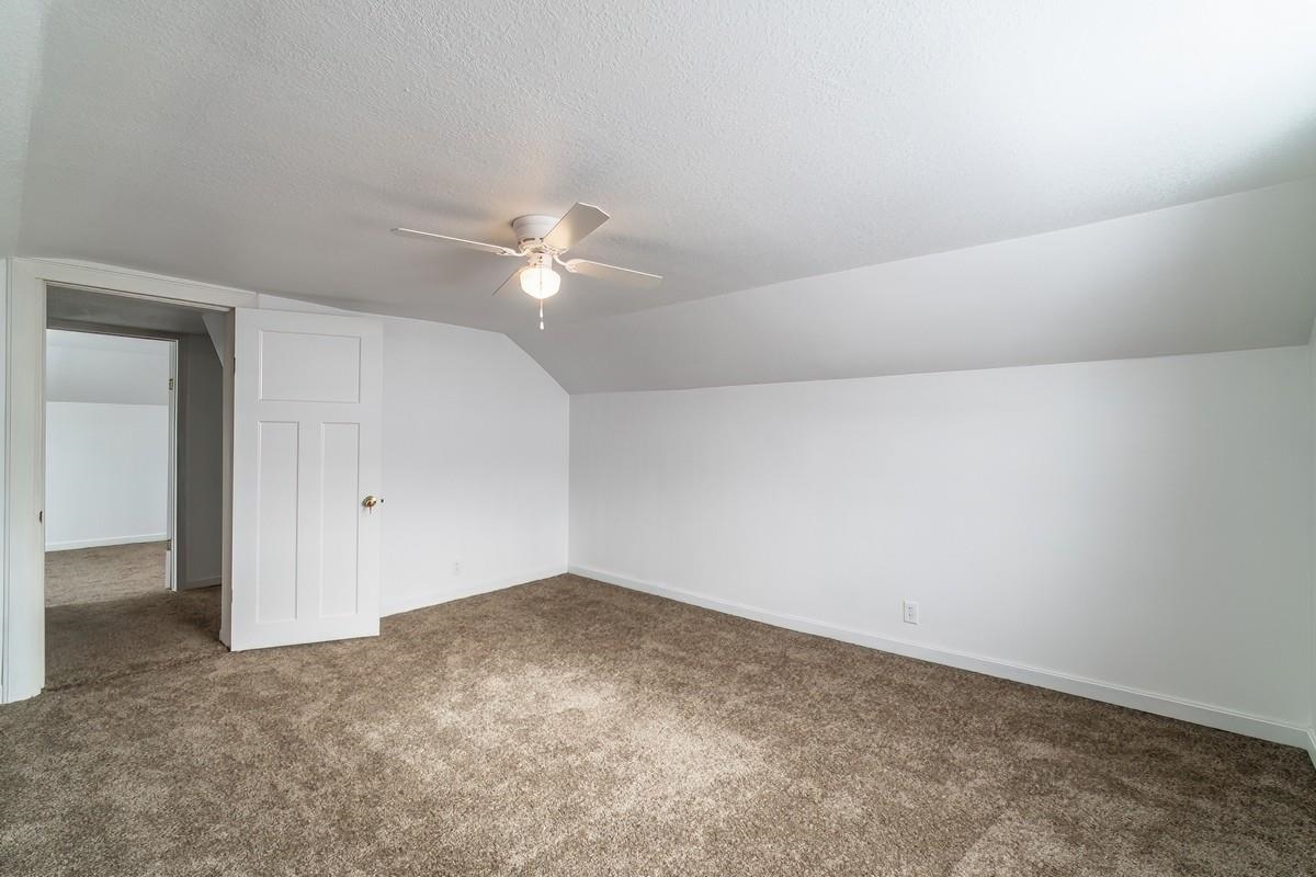 Bonus room featuring a ceiling fan and carpet floors
