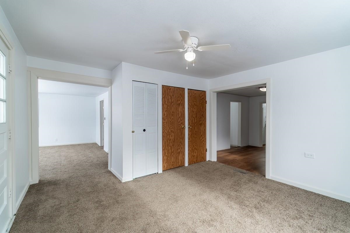 Unfurnished bedroom featuring a closet, ceiling fan, and carpet flooring
