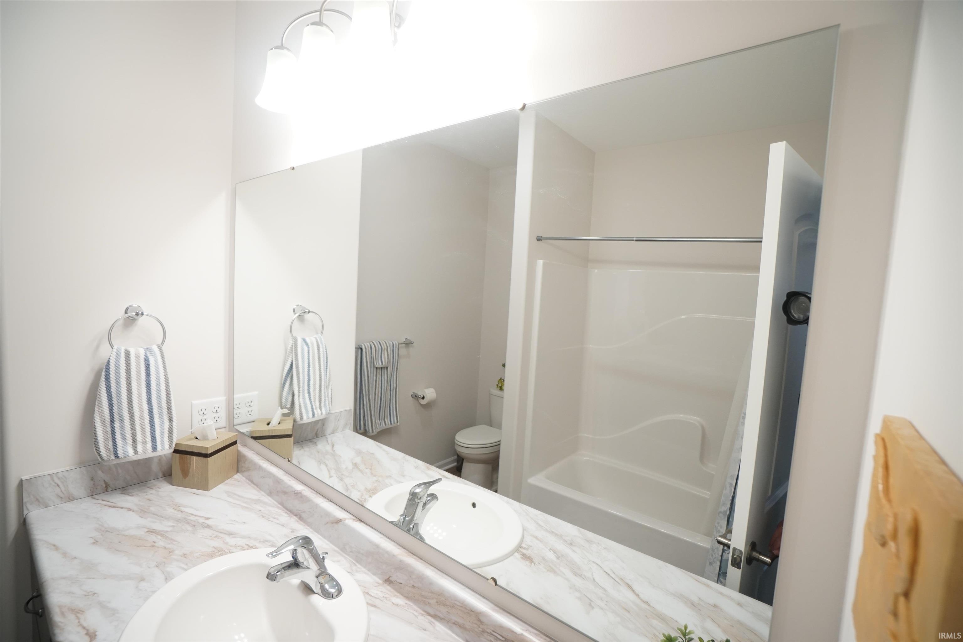 Bathroom featuring vanity and washtub / shower combination
