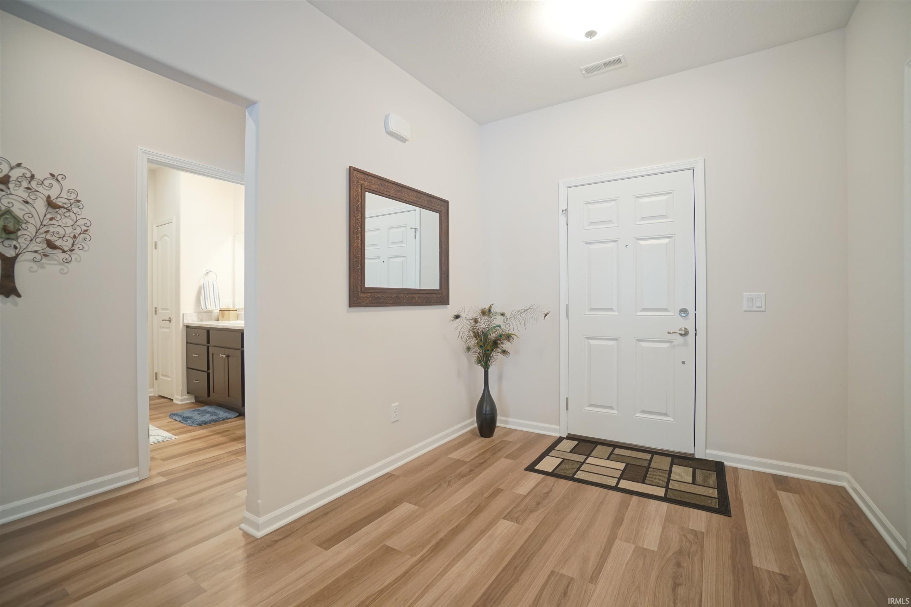 Entrance foyer featuring light wood-type flooring and baseboards