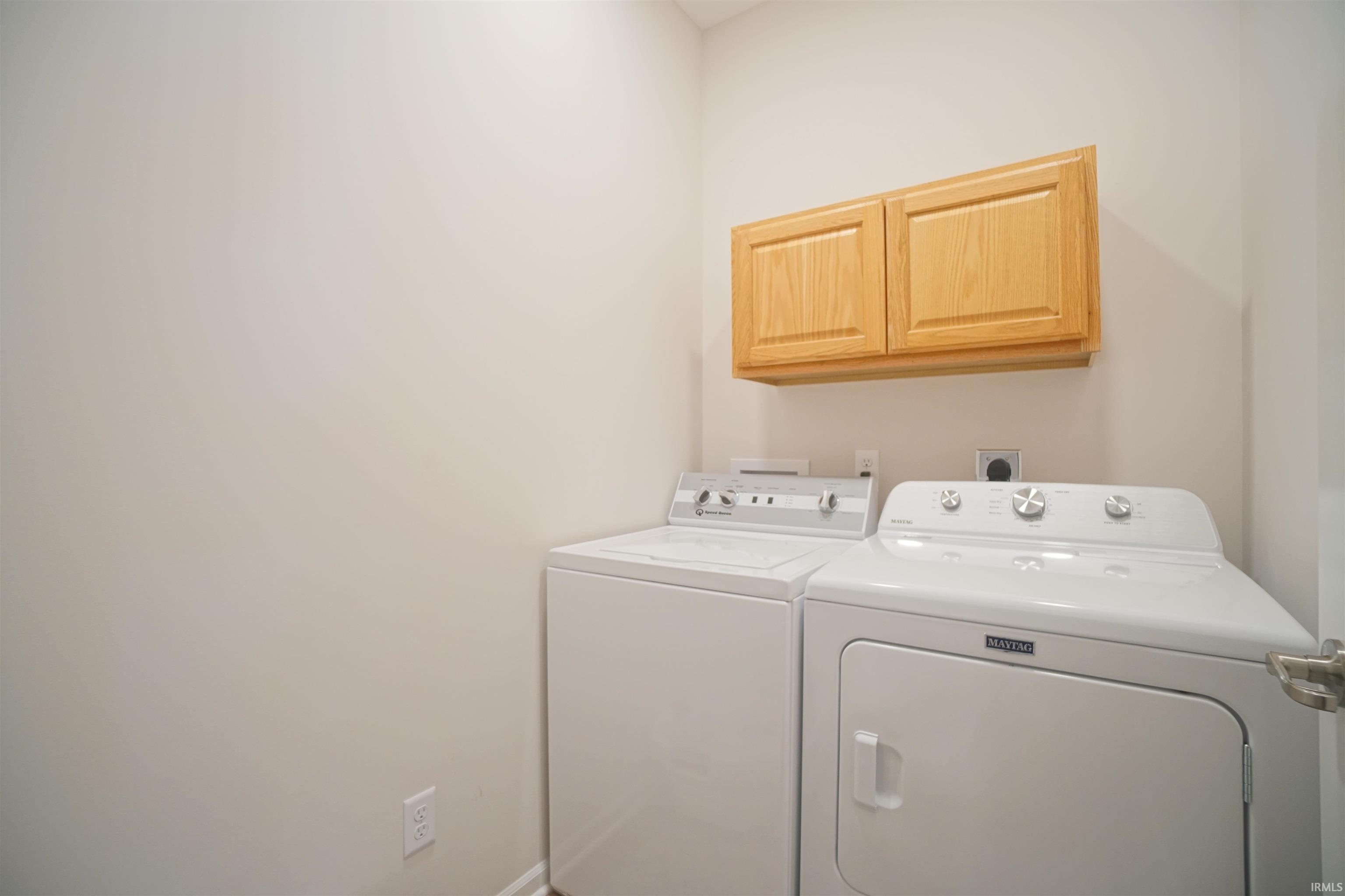 Laundry area featuring cabinet space and washing machine and dryer