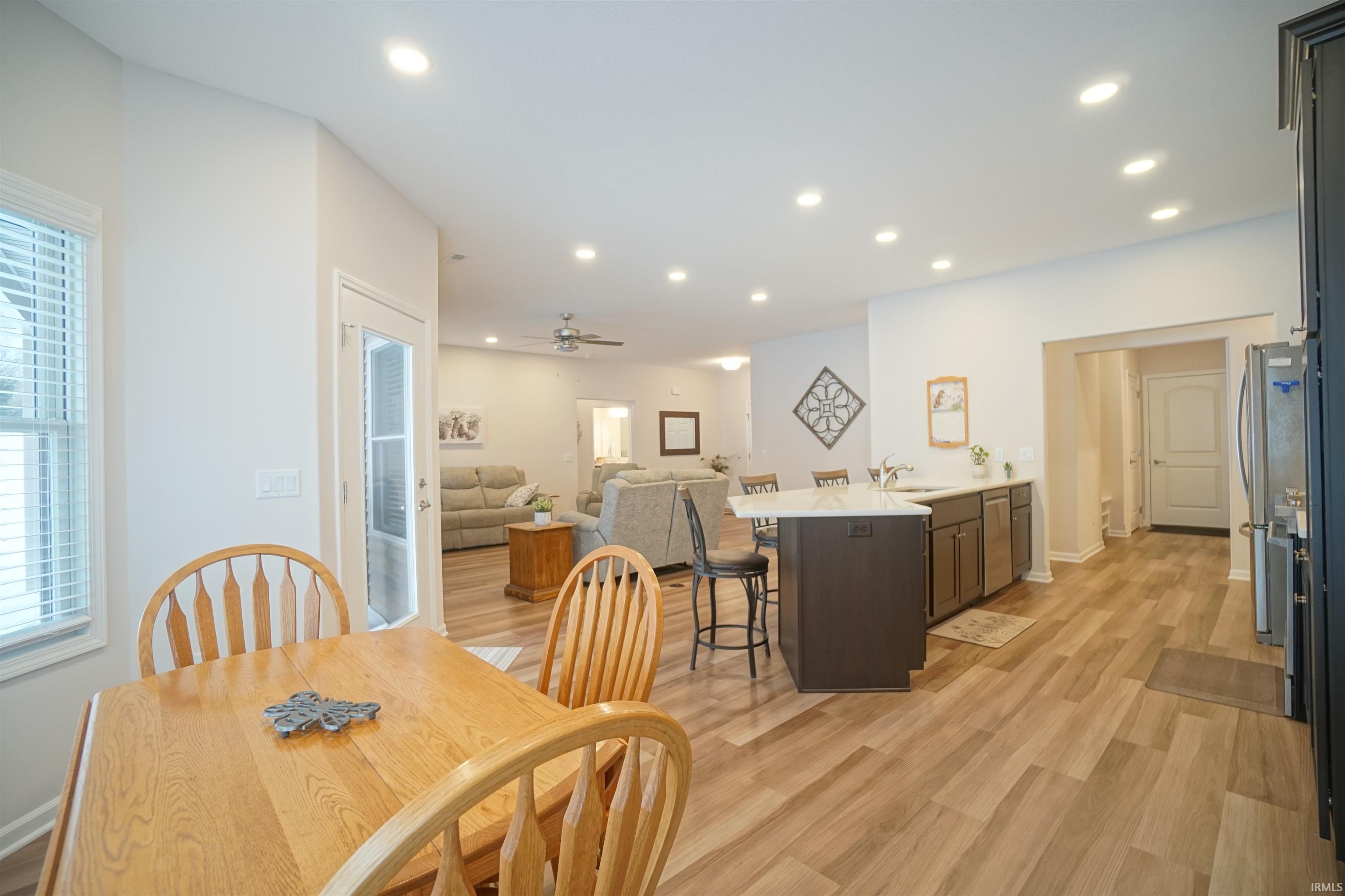 Dining room featuring light wood-style flooring, recessed lighting, and a ceiling fan