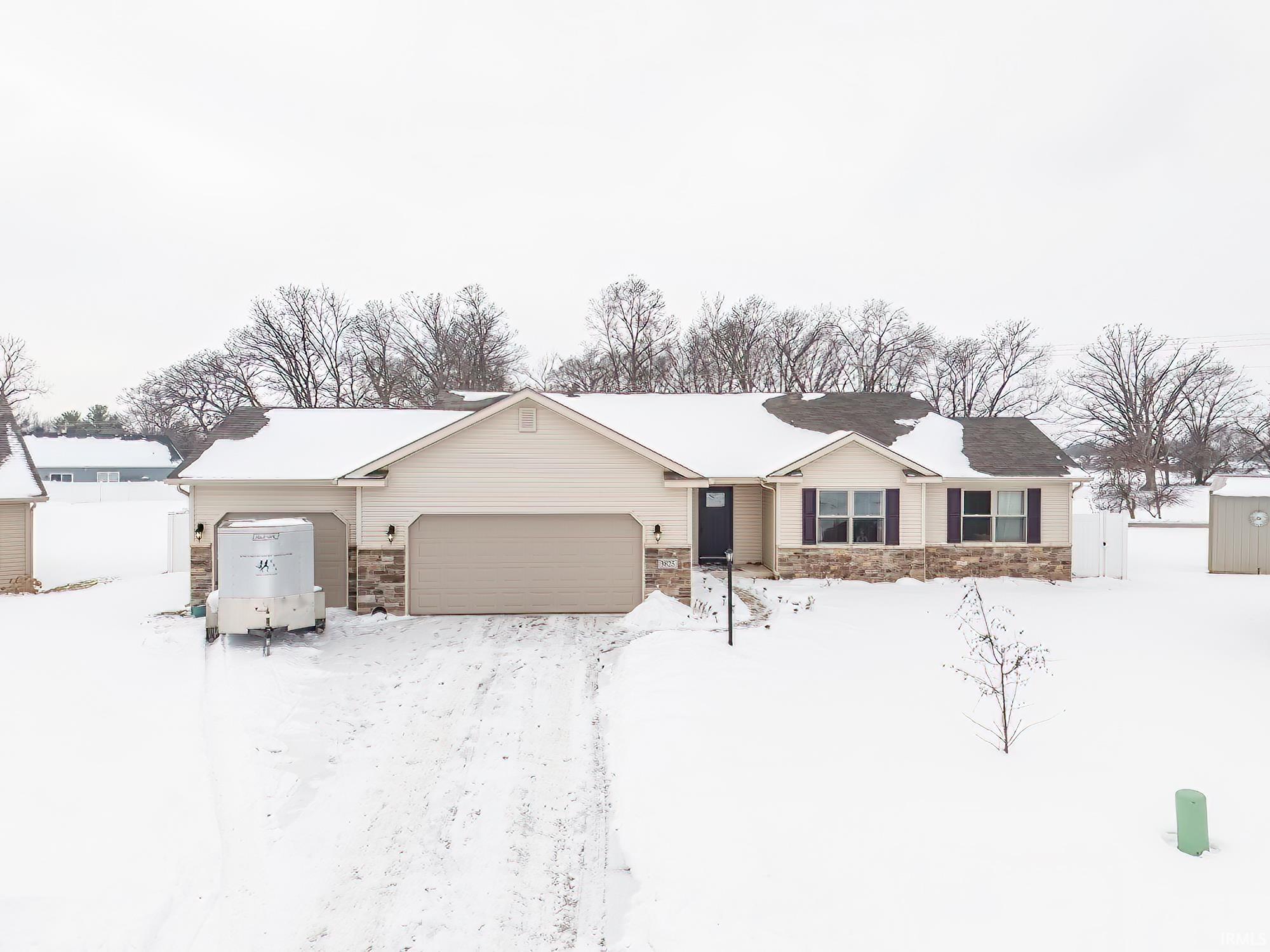 Ranch-style house featuring stone siding