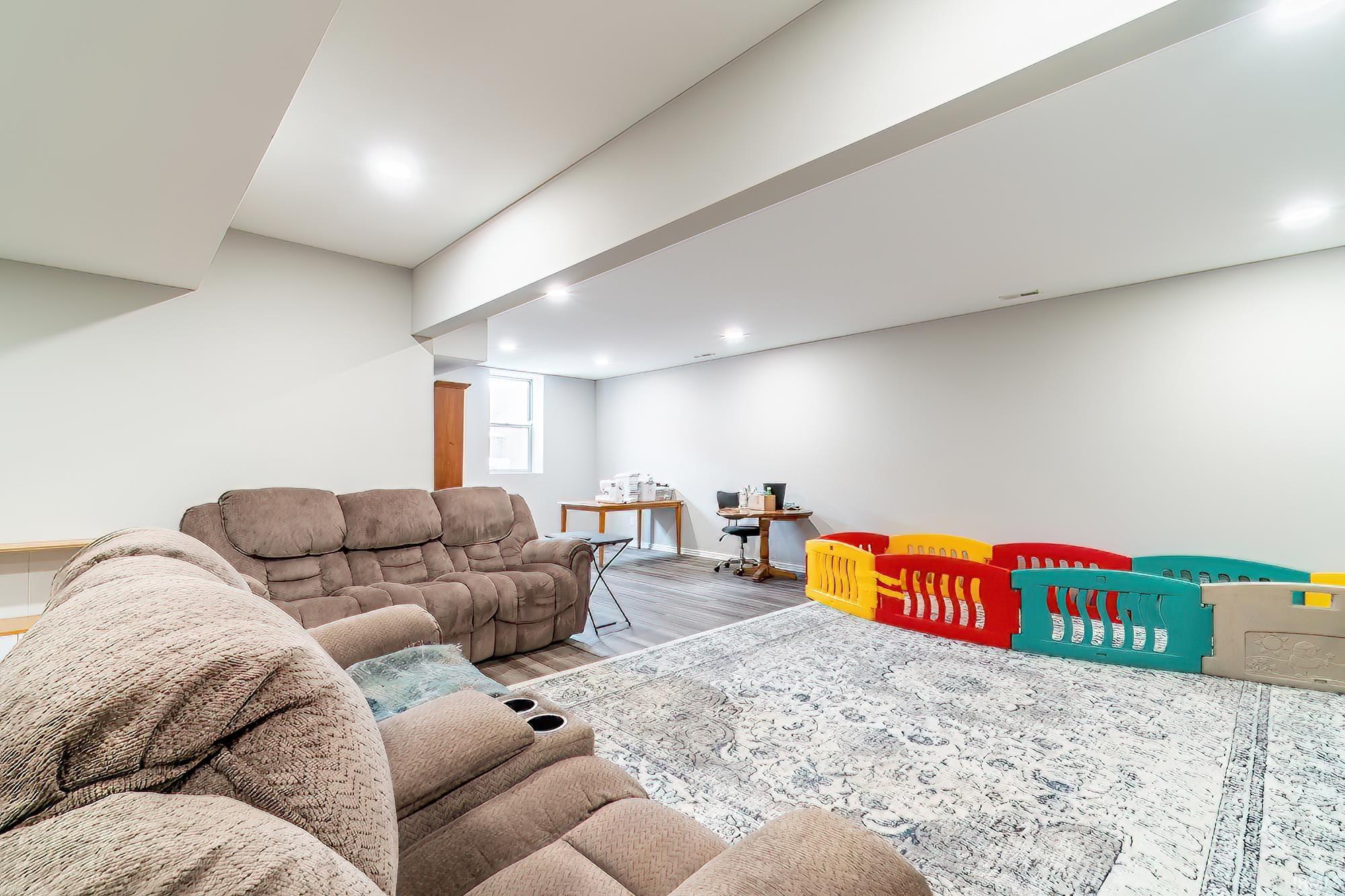 Living area with wood finished floors, recessed lighting, and a desk