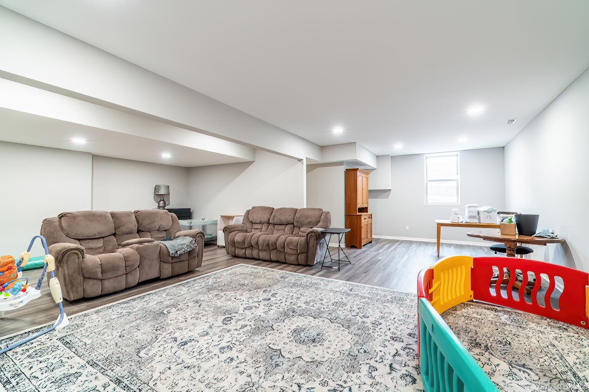 Living room with light wood-type flooring and baseboards
