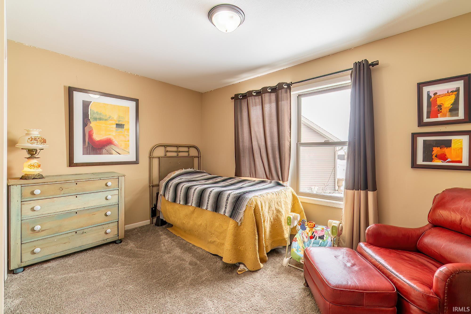 Carpeted bedroom featuring baseboards