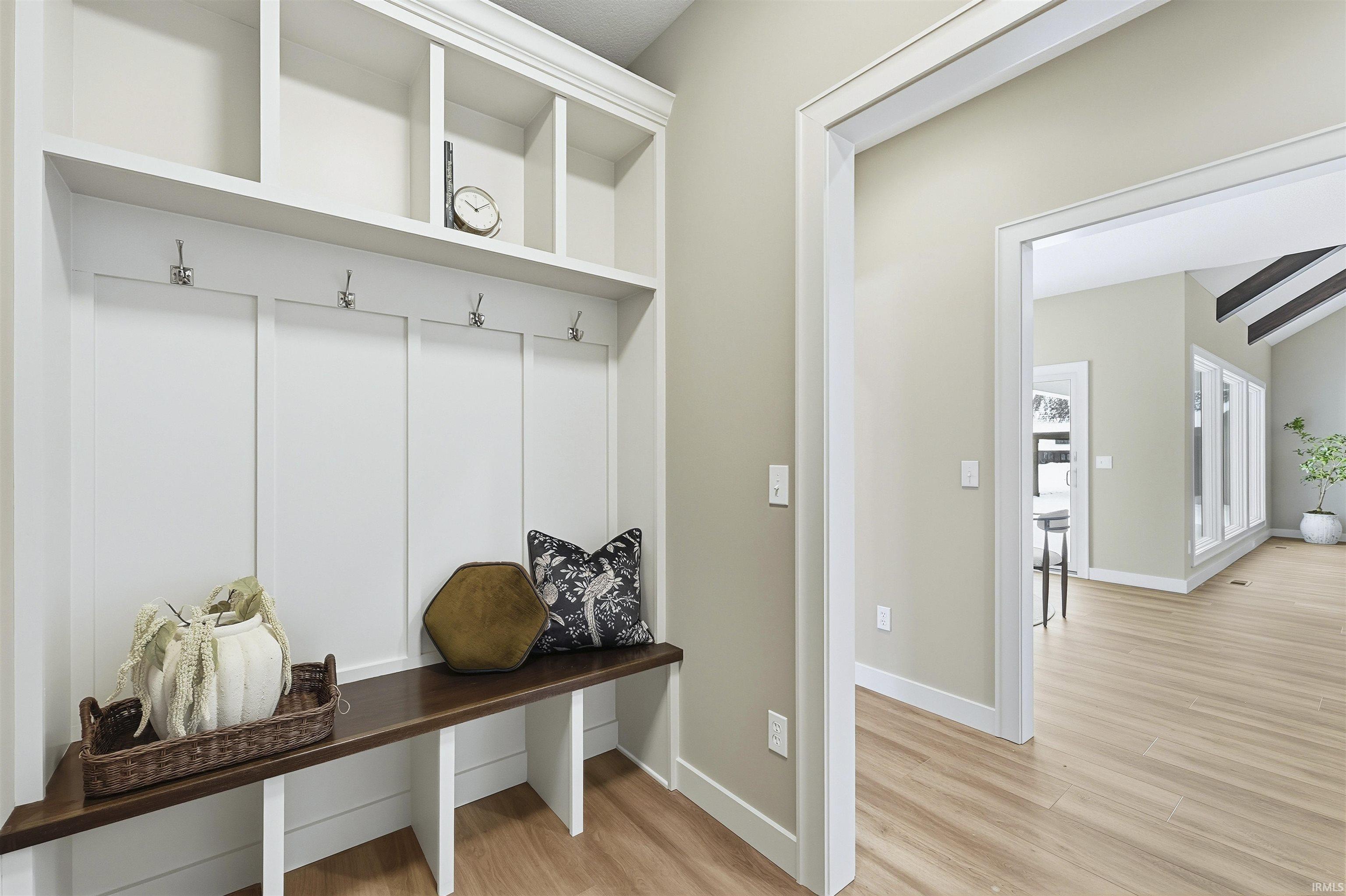 Mudroom with light wood-style floors and baseboards