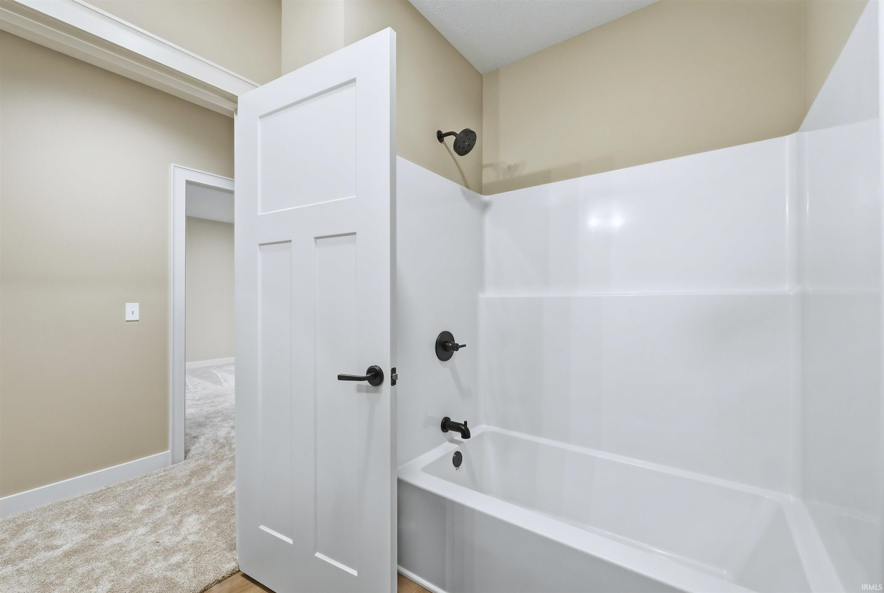 Bathroom with  shower combination and light carpet