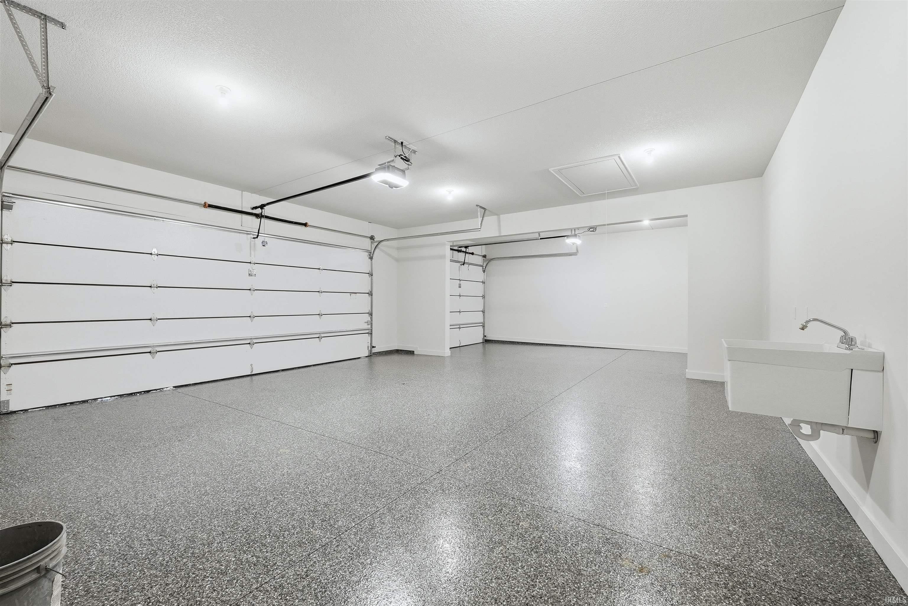 Garage with a sink and baseboards