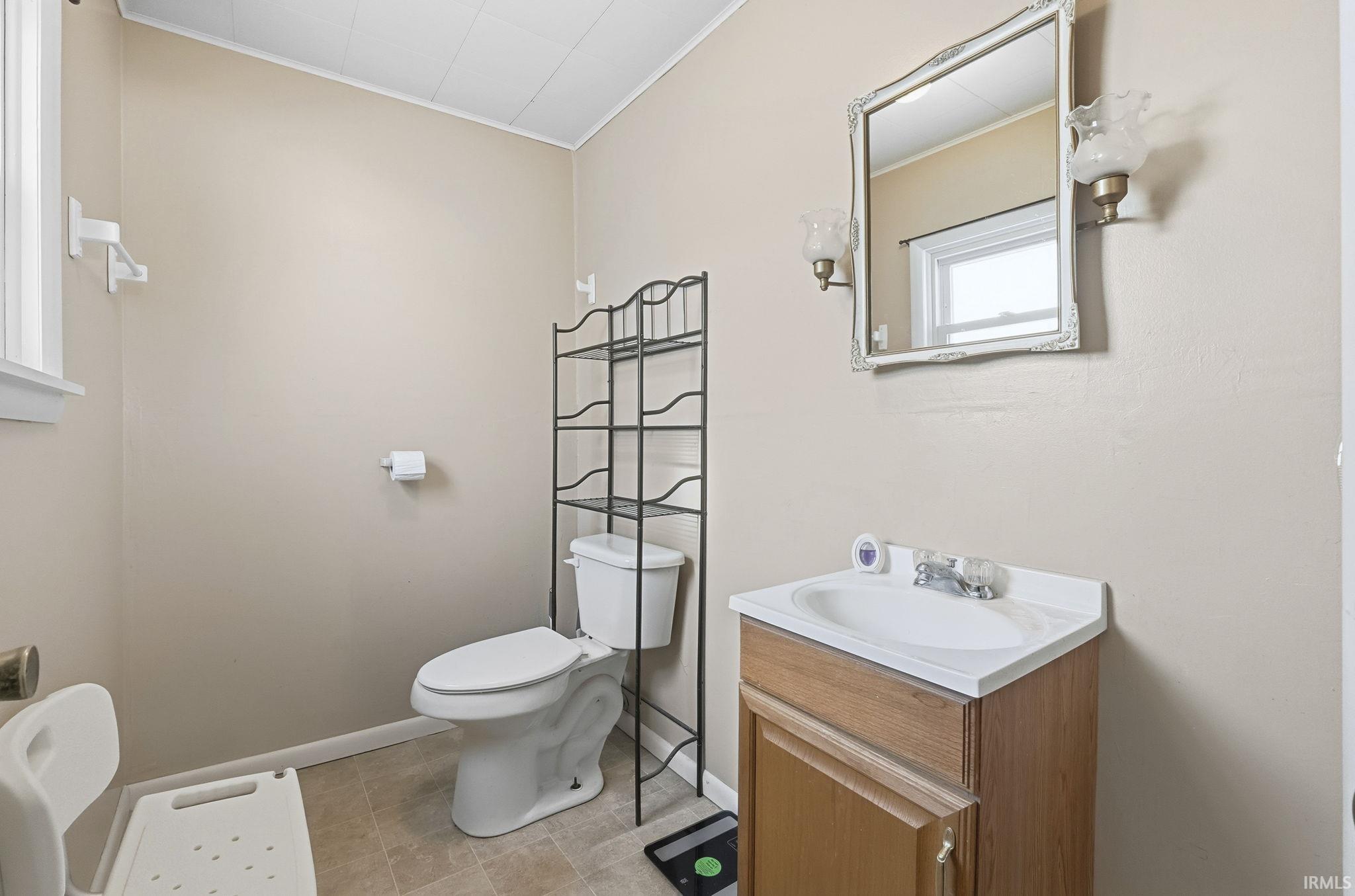 Bathroom featuring vanity and ornamental molding