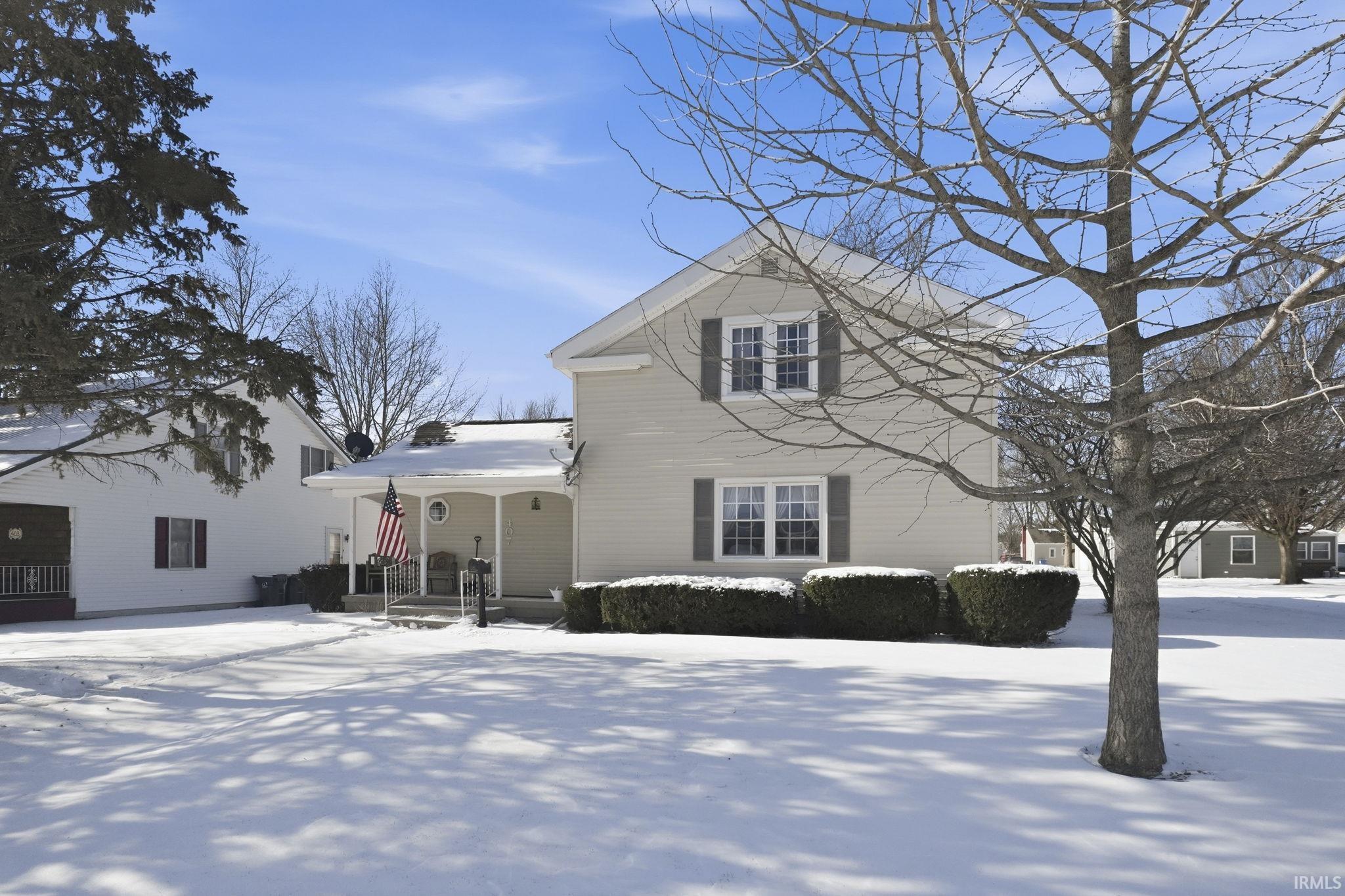 Traditional-style home featuring a porch