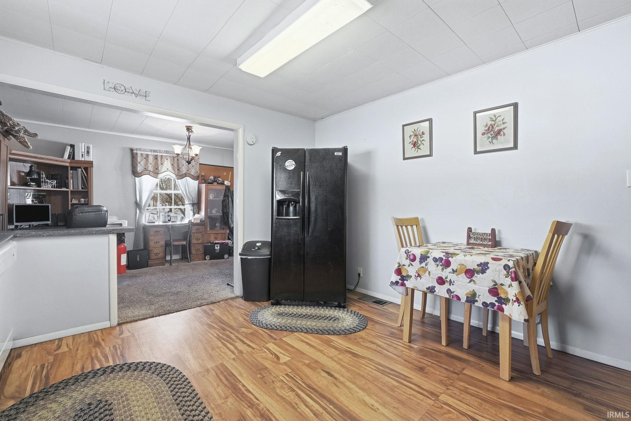 Dining space featuring light wood-style flooring and suspended lighting