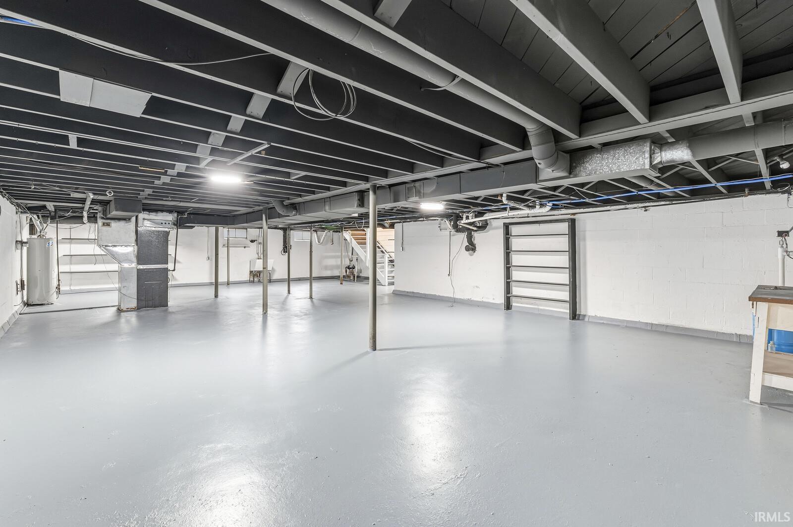 Below grade area featuring gas water heater and heating unit