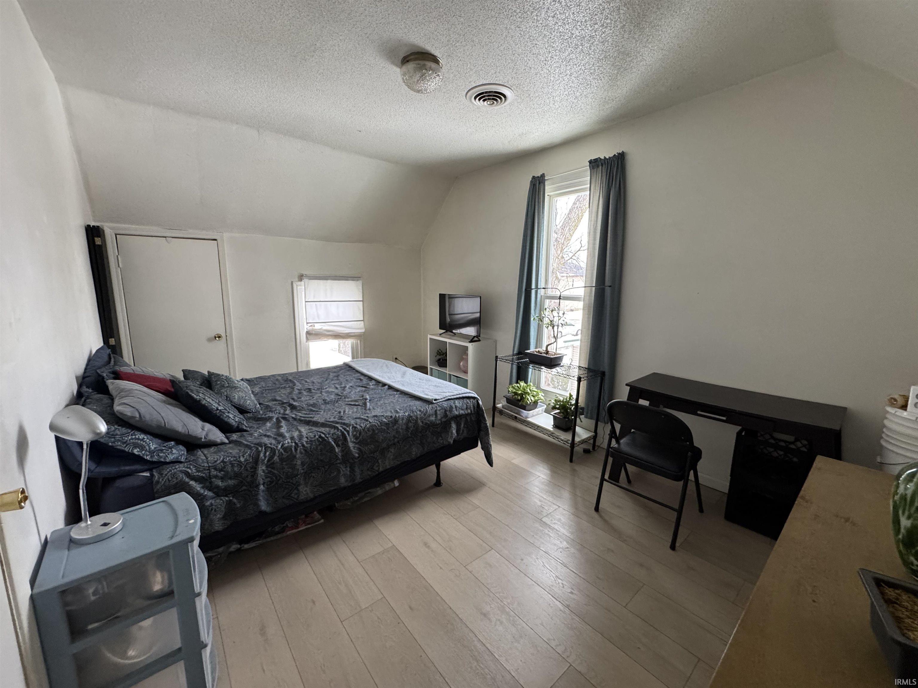Bedroom featuring wood-type flooring