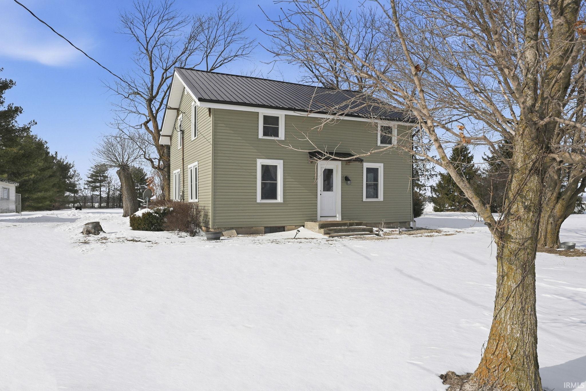 View of front of house with a metal roof