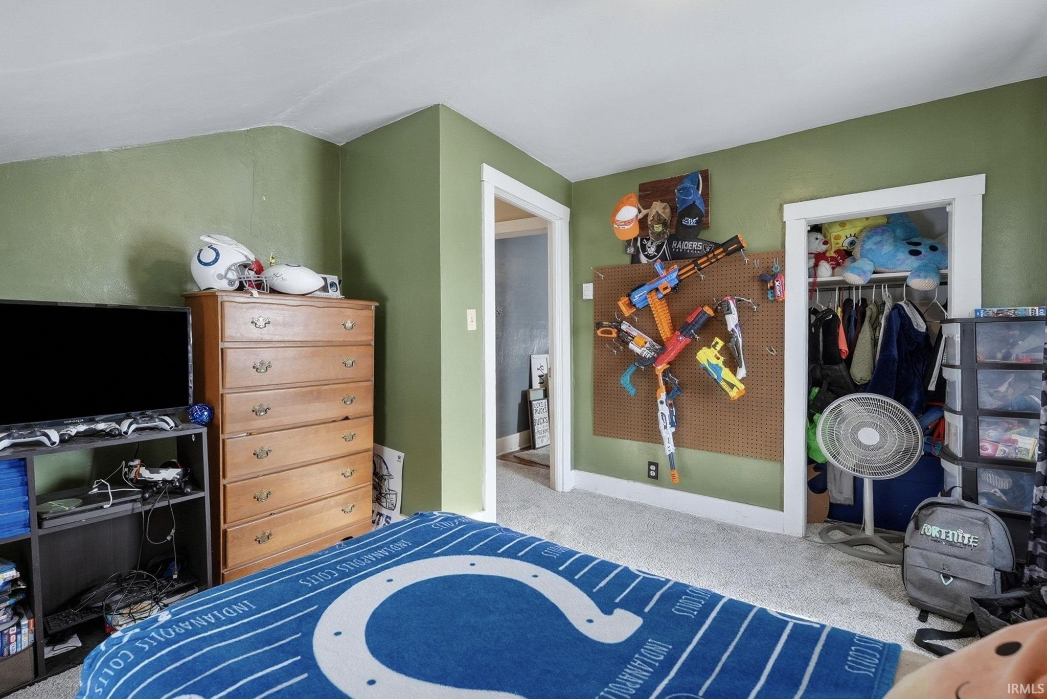 Bedroom featuring carpet and a closet