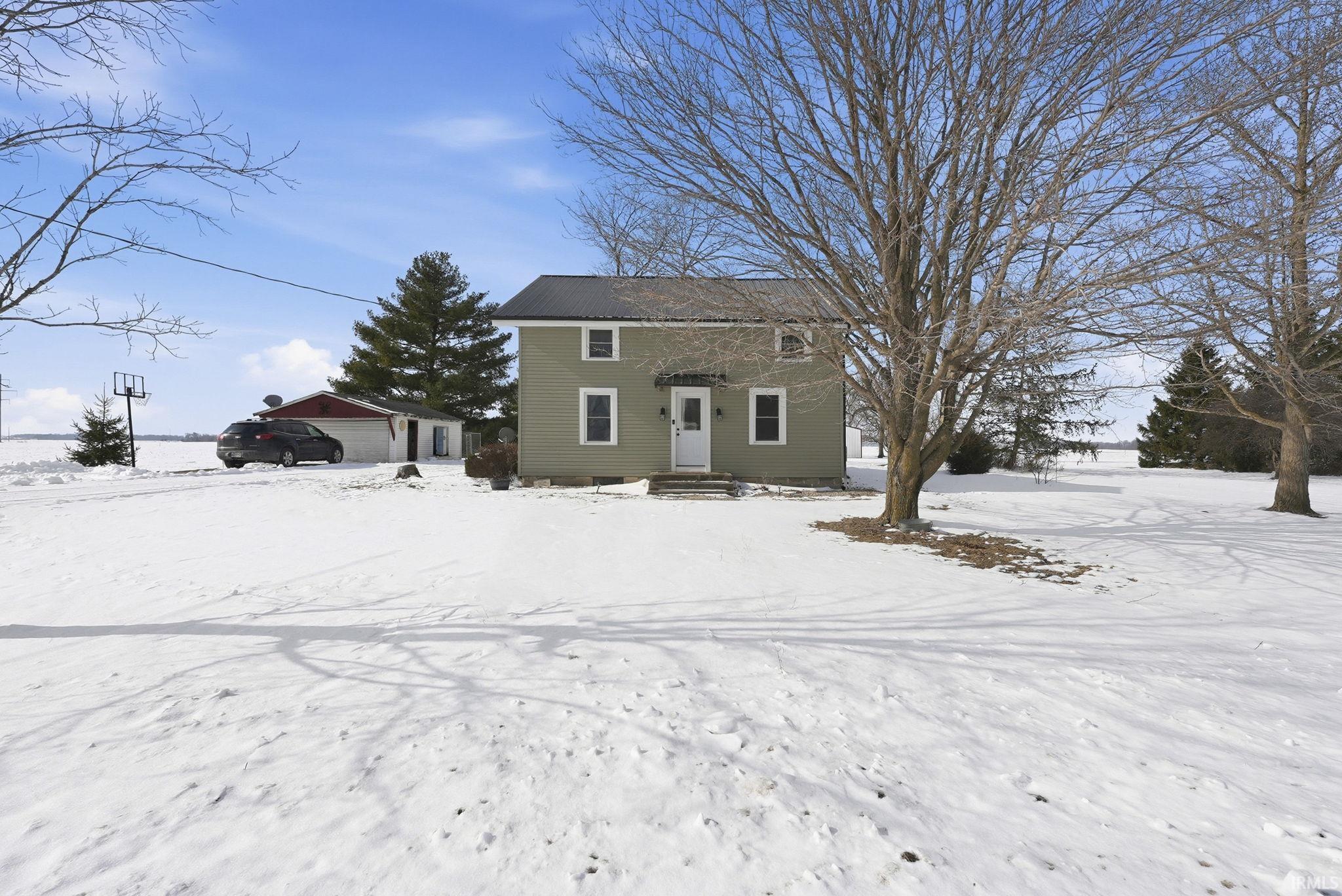View of front of home with an outdoor structure