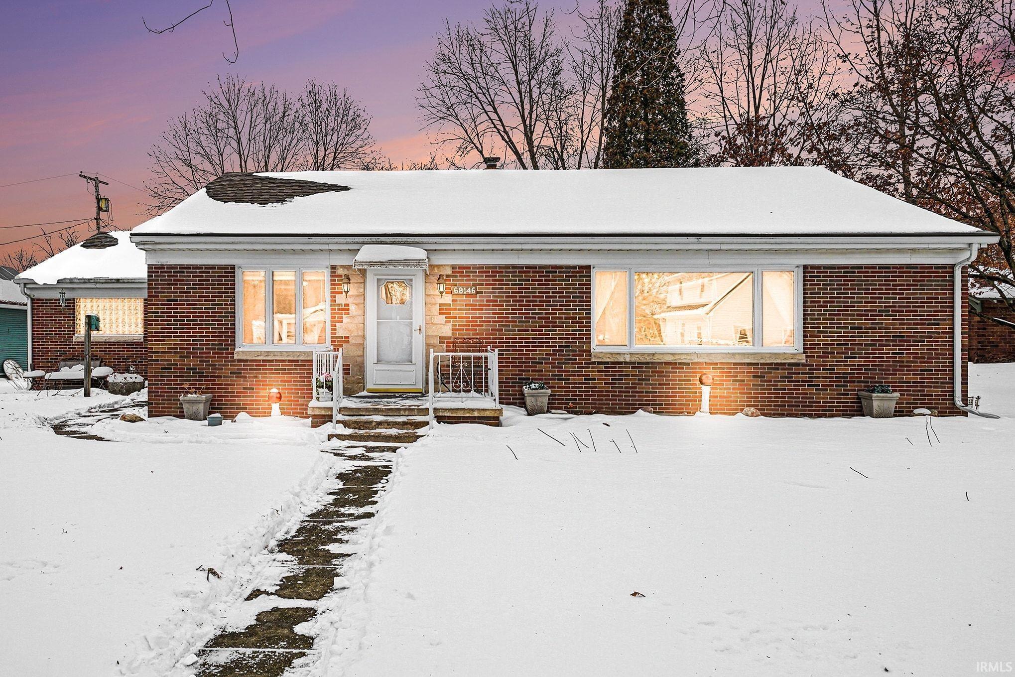 Bungalow-style home with brick siding