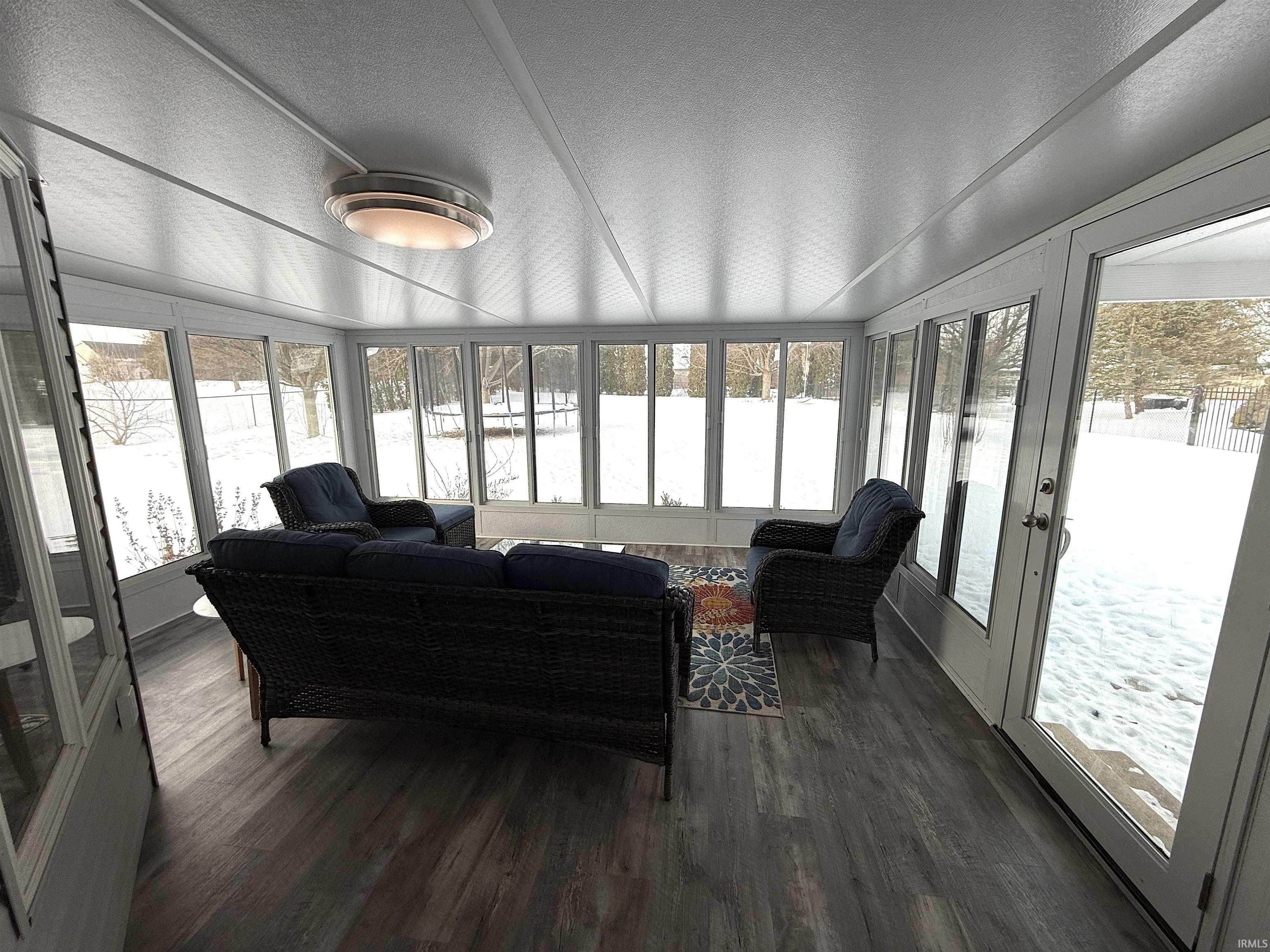 Sunroom featuring french doors and an outdoor lounge area