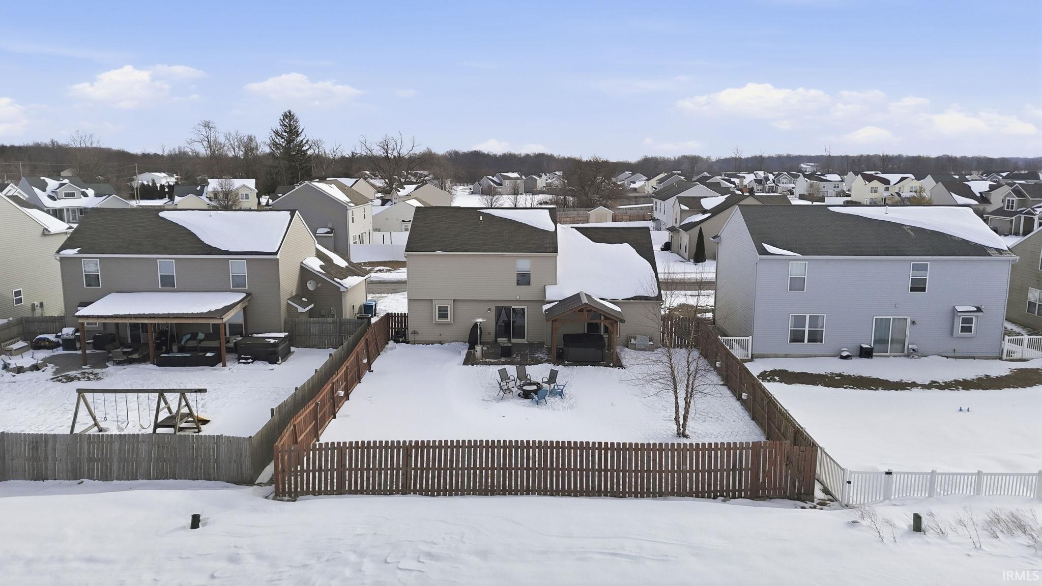 Rear view of house with a residential view, a fenced backyard, and a deck
