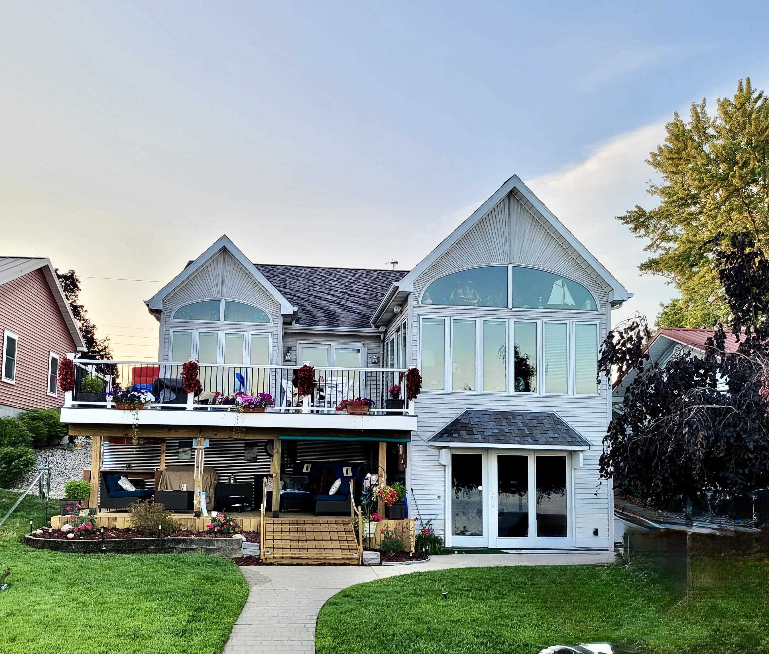 Back of house with a yard and a shingled roof