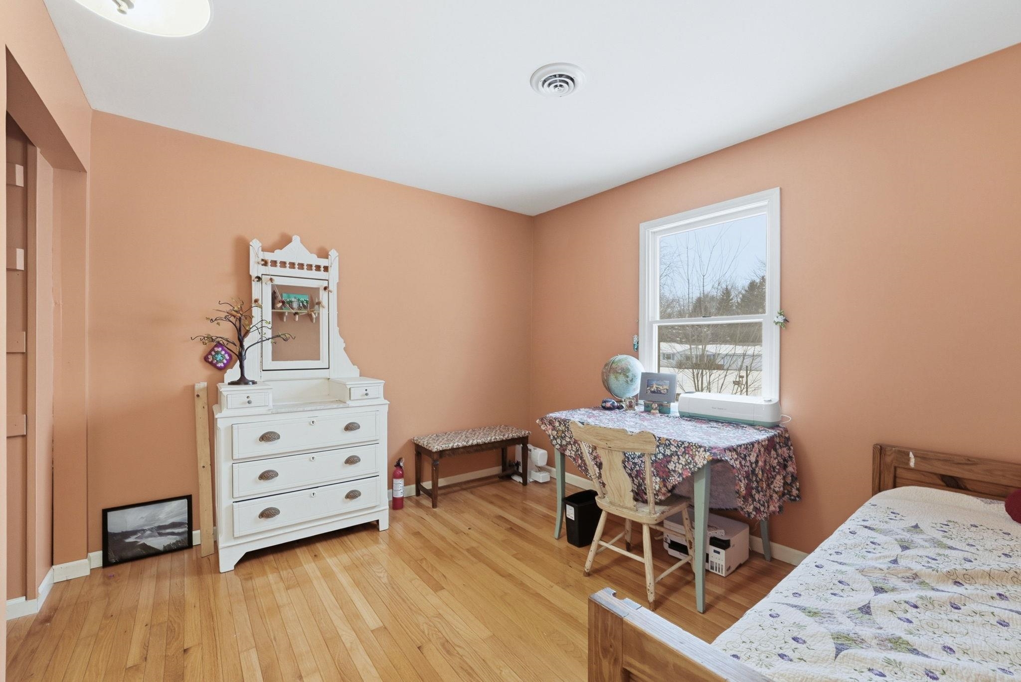 Bedroom with light wood-type flooring and baseboards