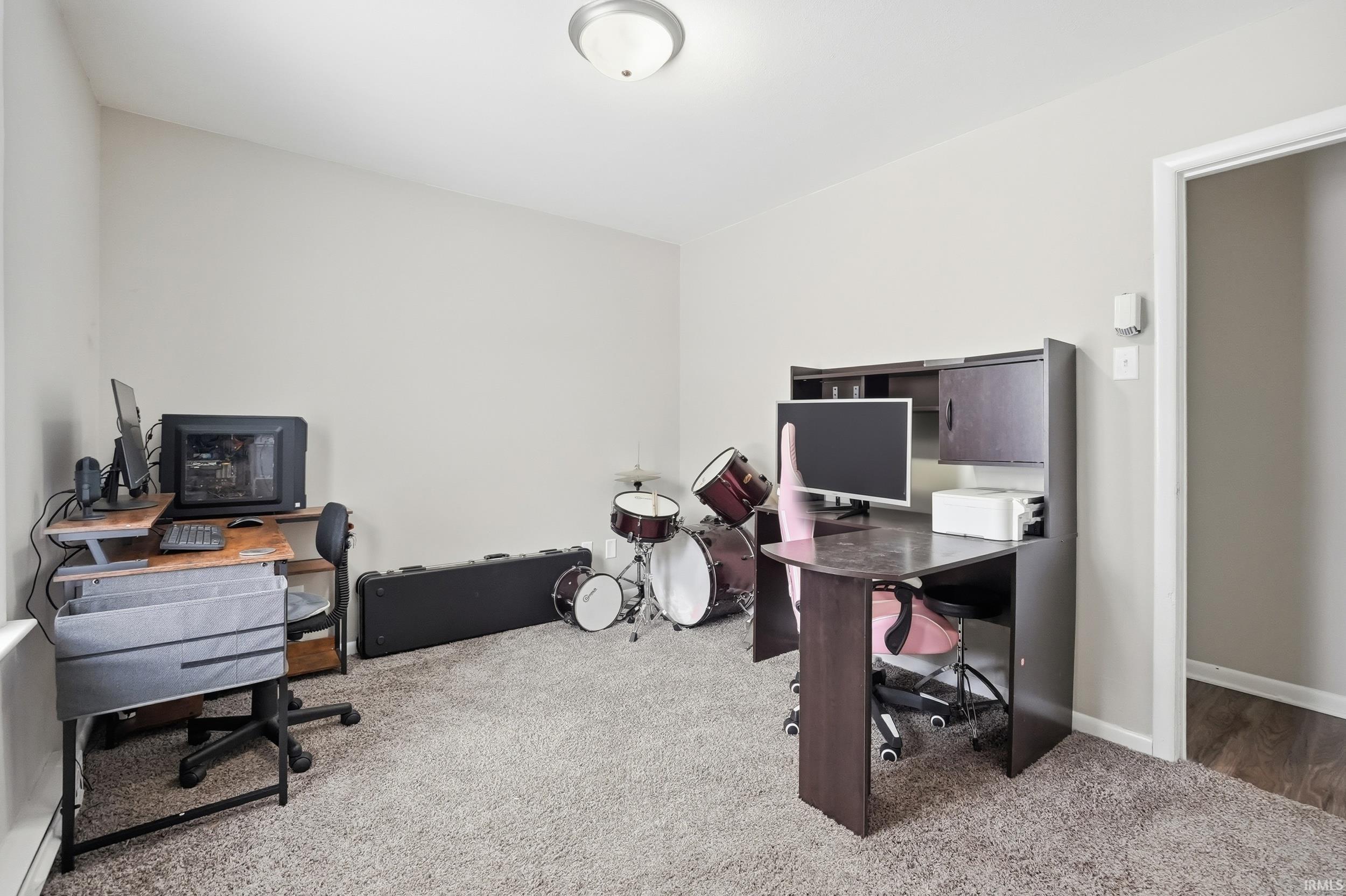 Home office featuring light colored carpet