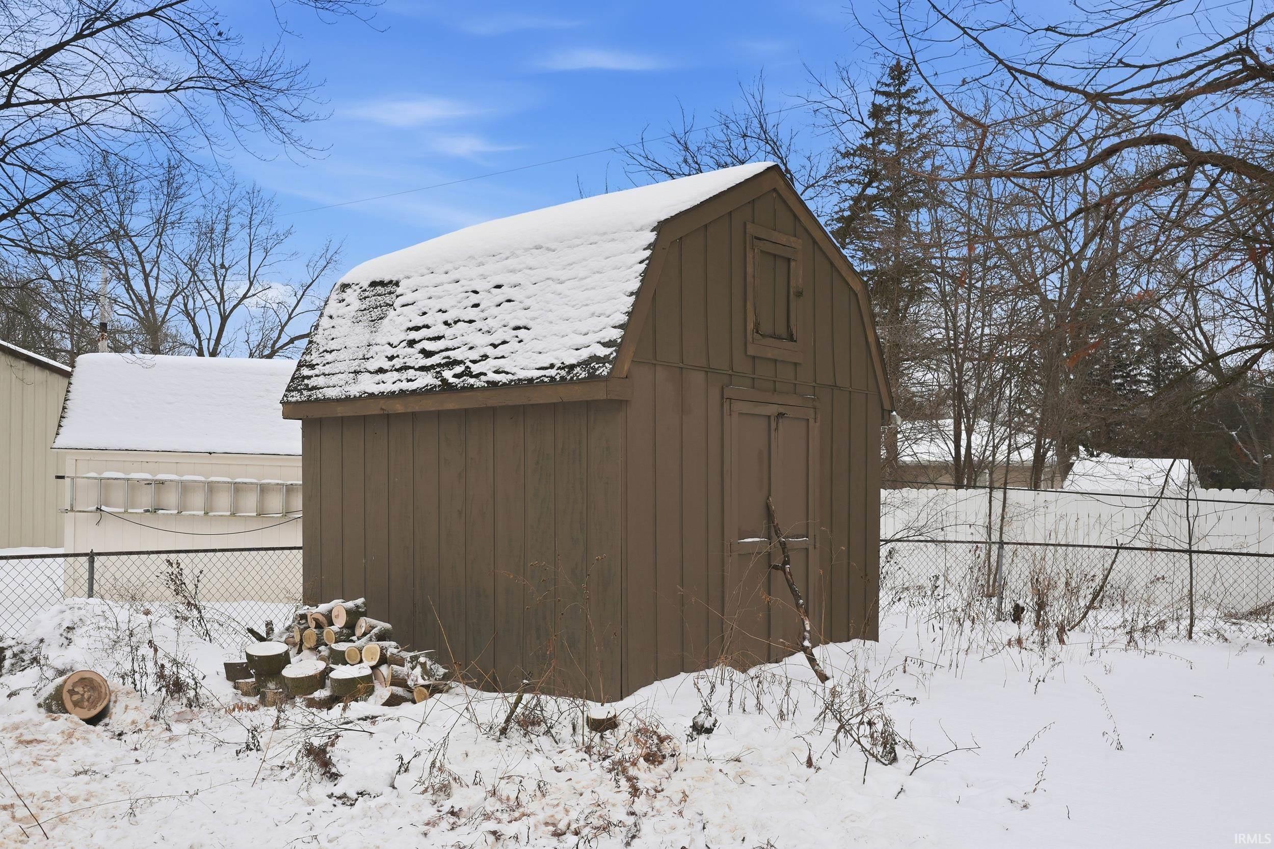 Snow covered structure with a storage shed