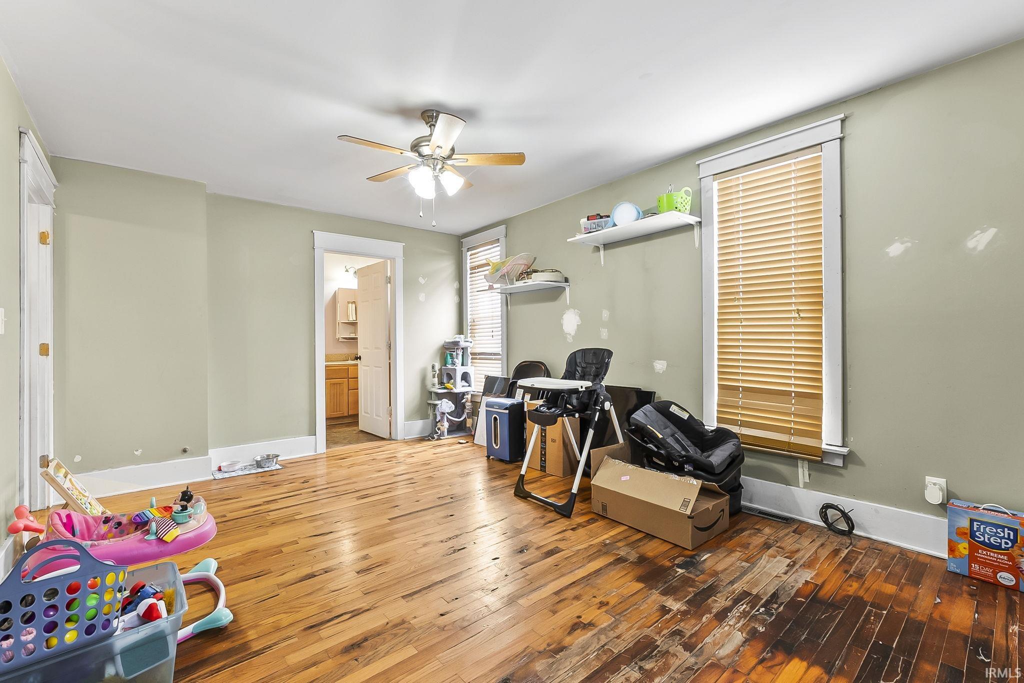 Rec room with wood-type flooring and a ceiling fan