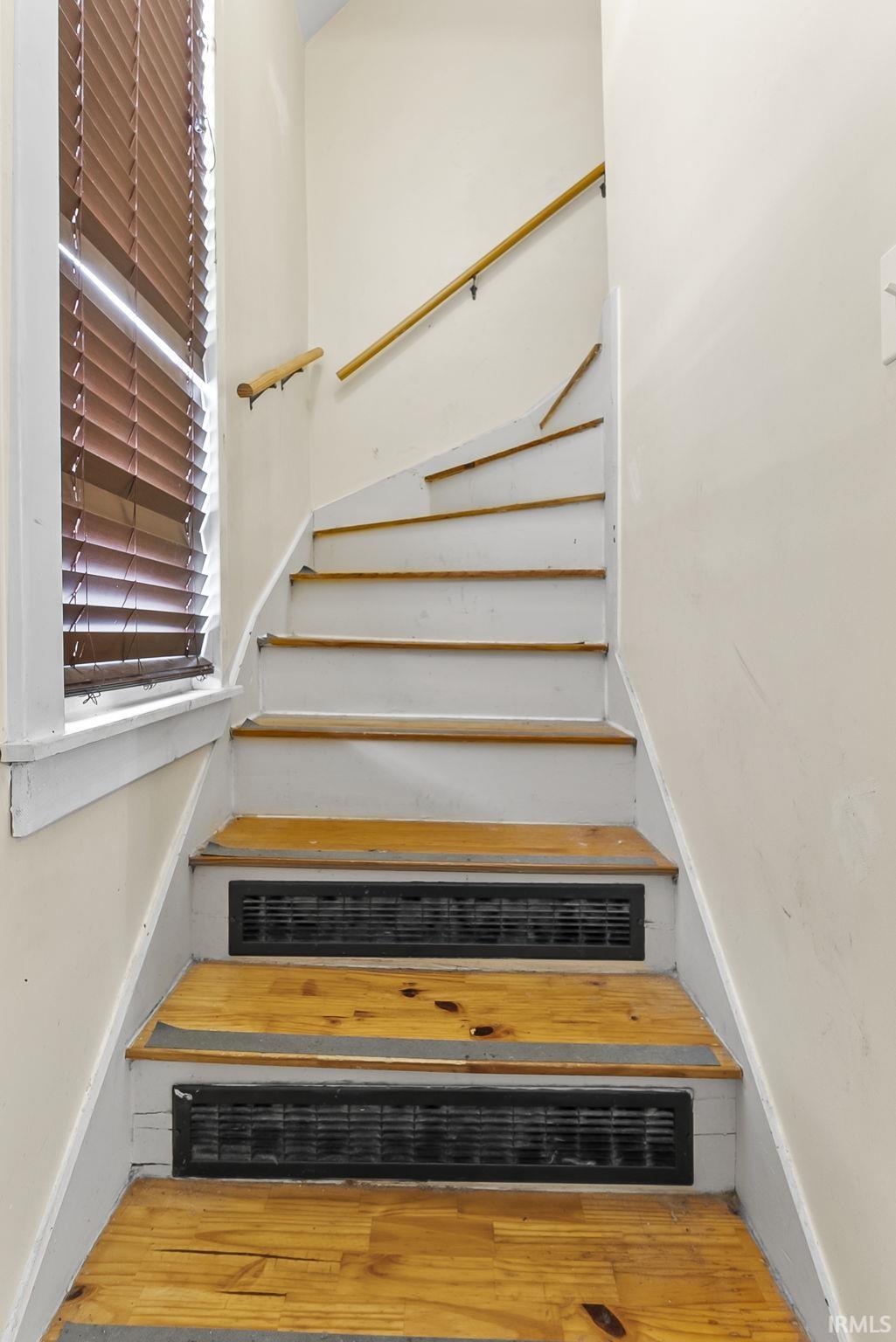Stairway with hardwood / wood-style flooring
